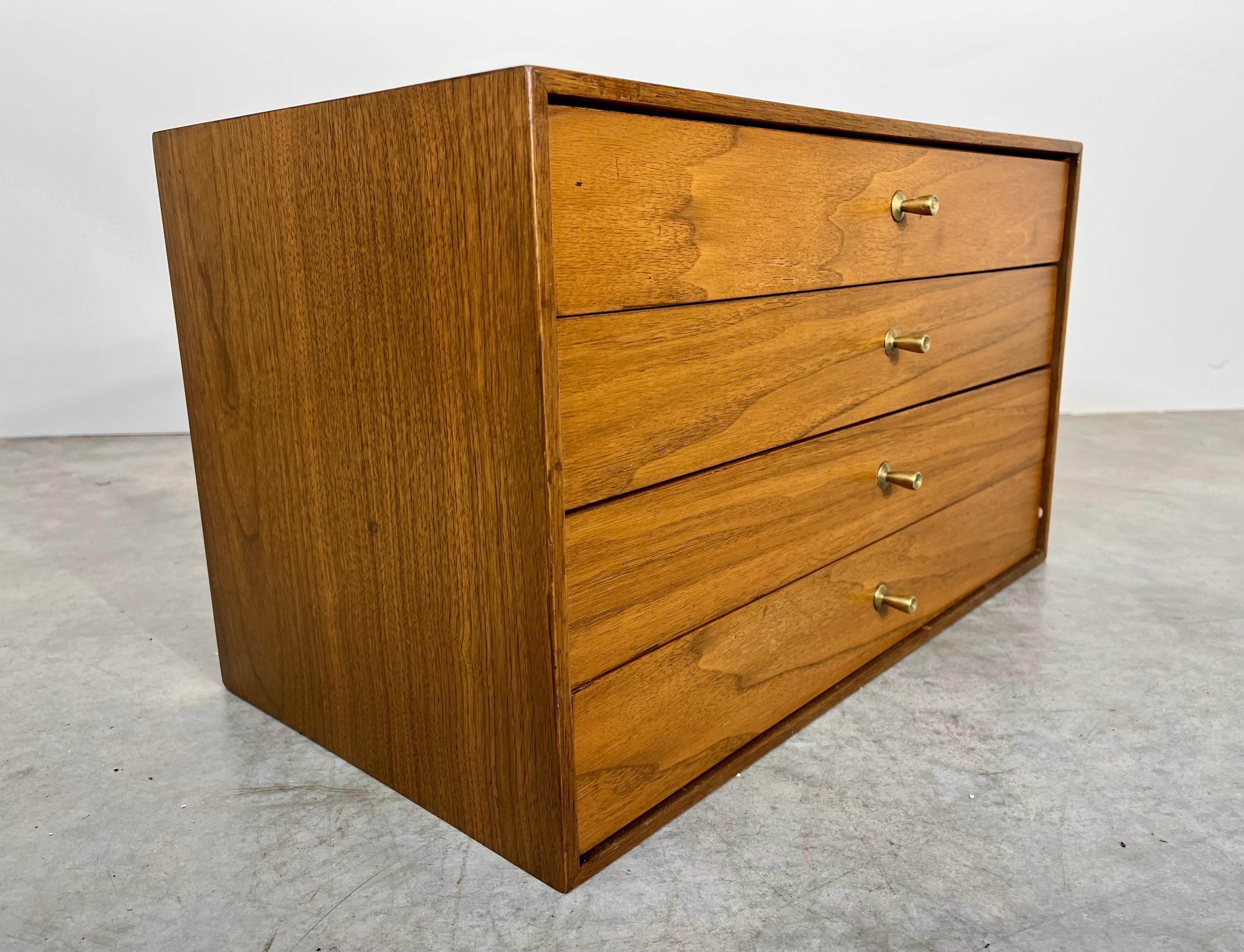 Mid-century 4-drawer walnut storage box in the manner of Paul McCobb. The perfect addition to your Mid-century layout. Ideal for jewelry, silverware or as a catchall. 
Measures: 13x22x12” HWD.