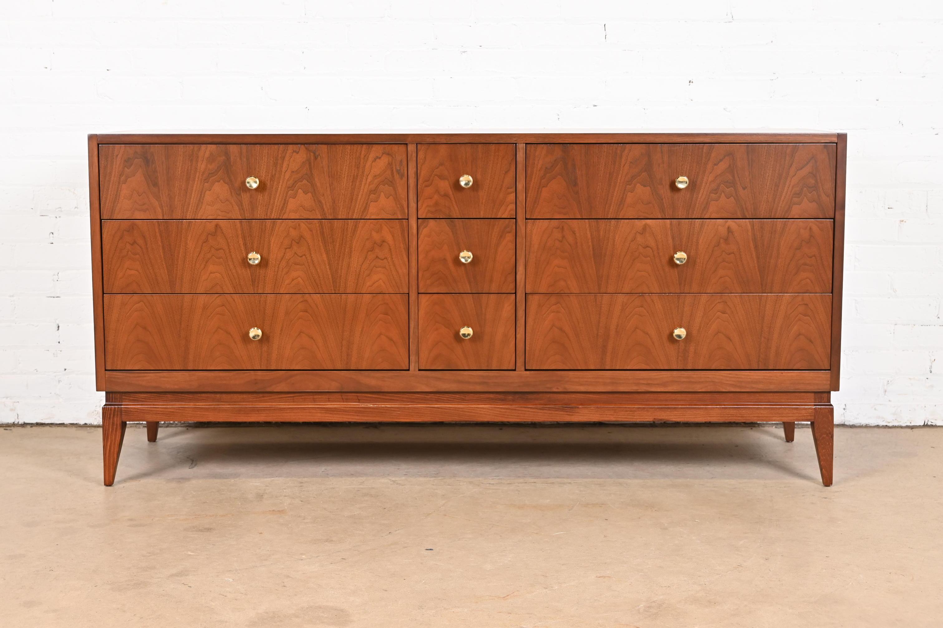 An exceptional Mid-Century Modern long dresser or credenza

In the style of Paul McCobb

By National Furniture of Mount Airy

USA, 1960s

Gorgeous book-matched walnut, with original brass drawer pulls.

Measures: 63