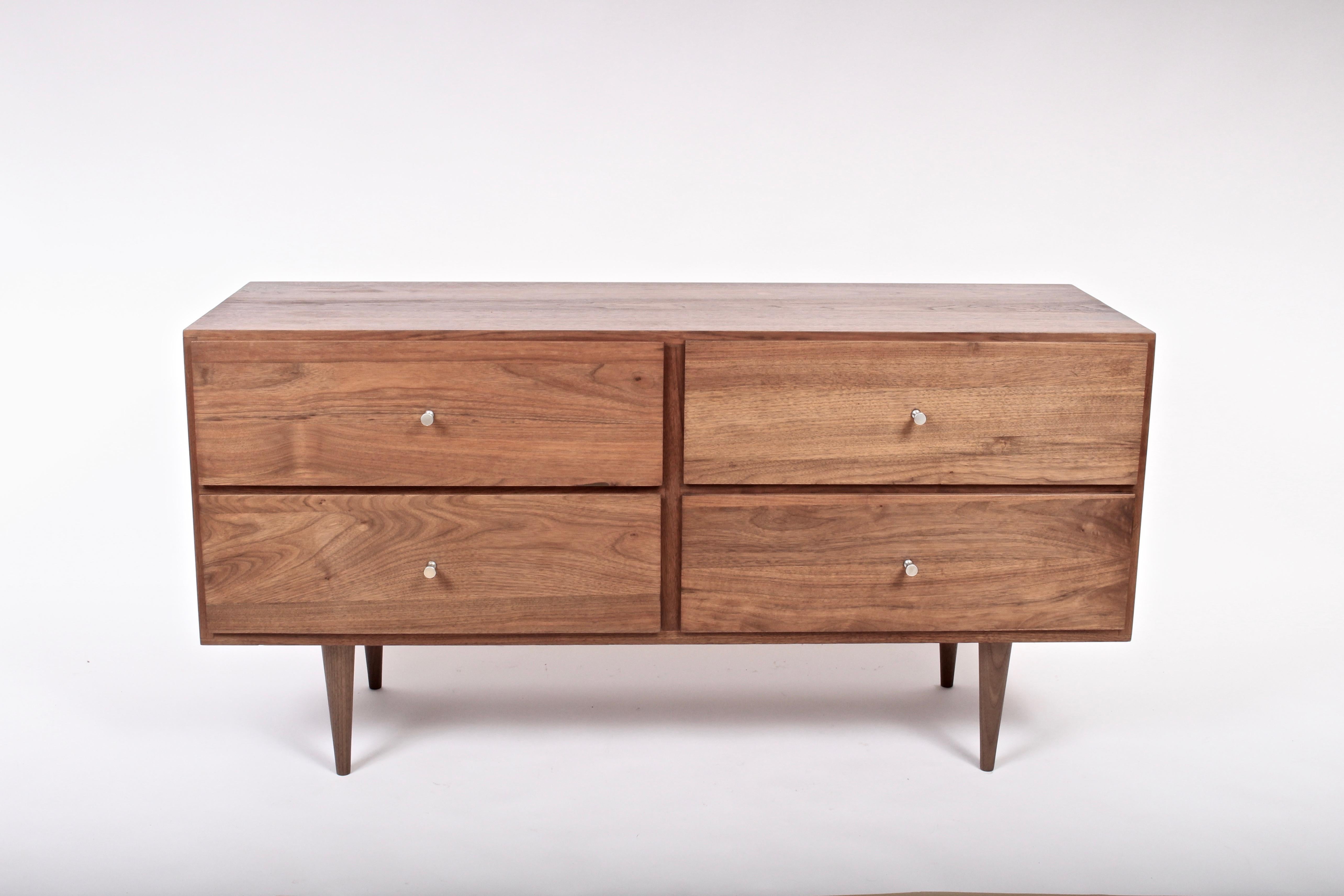 American Mid-Century Modern Country Workshop solid black walnut four drawer nightstand, low dresser. In the manner of Paul McCobb. Rectangular, stackable, excellent storage and nickel-plated drawer pulls. Can be utilized as modular furniture. Legs