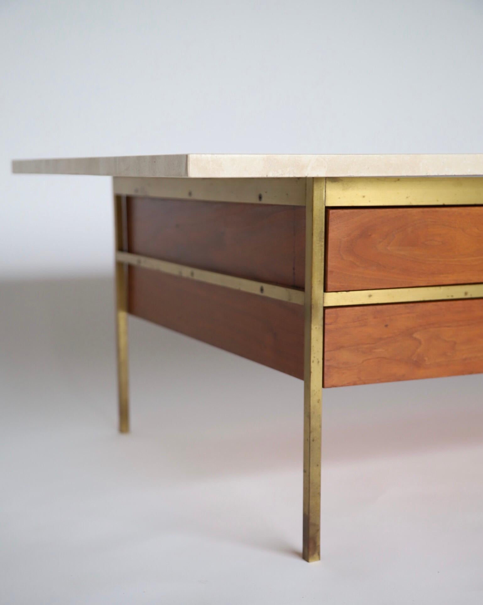 A stunning coffee table by Paul McCobb for Calvin. Travertine top, walnut body, two drawers and a shelf. A cocktail table for the ages.