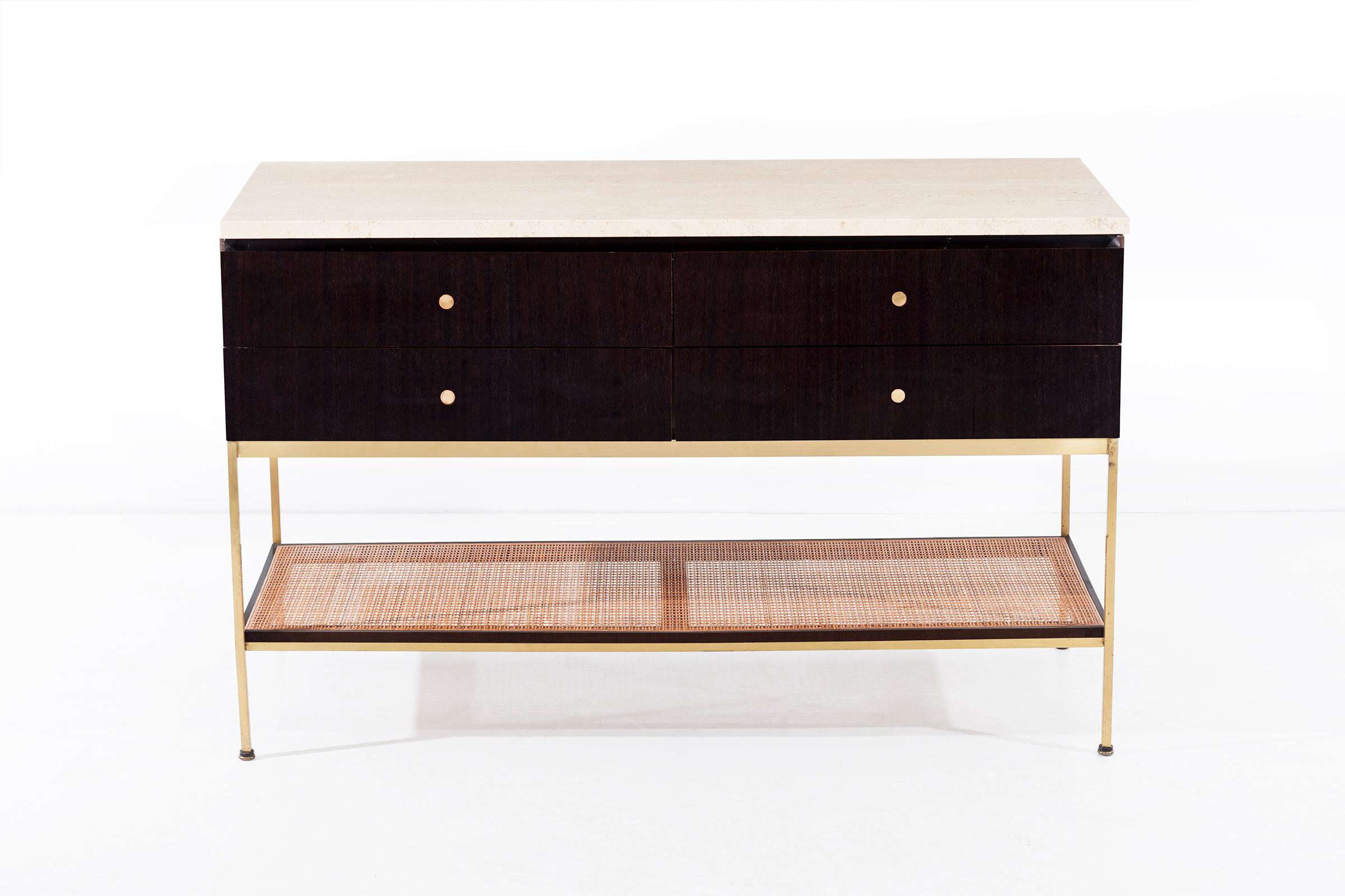 McCobb for Calvin of Grand Rapids, Irwin collection console, features 4 mahogany drawers and case with travertine top, brass frame and cane lower shelf.
Finished an all sides and can float in any space.