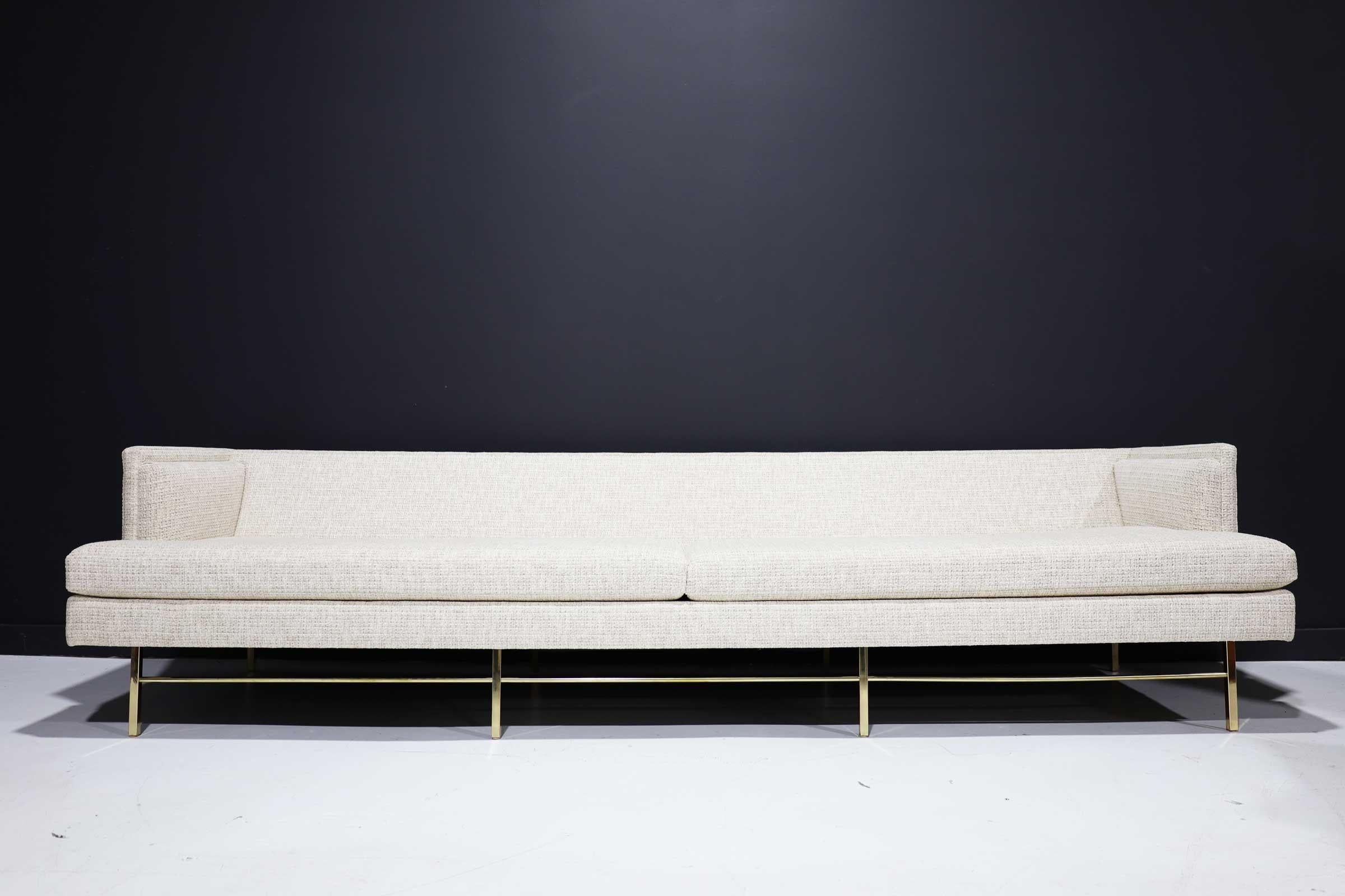 Beautifully restored Paul McCobb sofa in high quality chenille. Legs re-plated and polished and new upholstery in off-white chenille with gold threads.