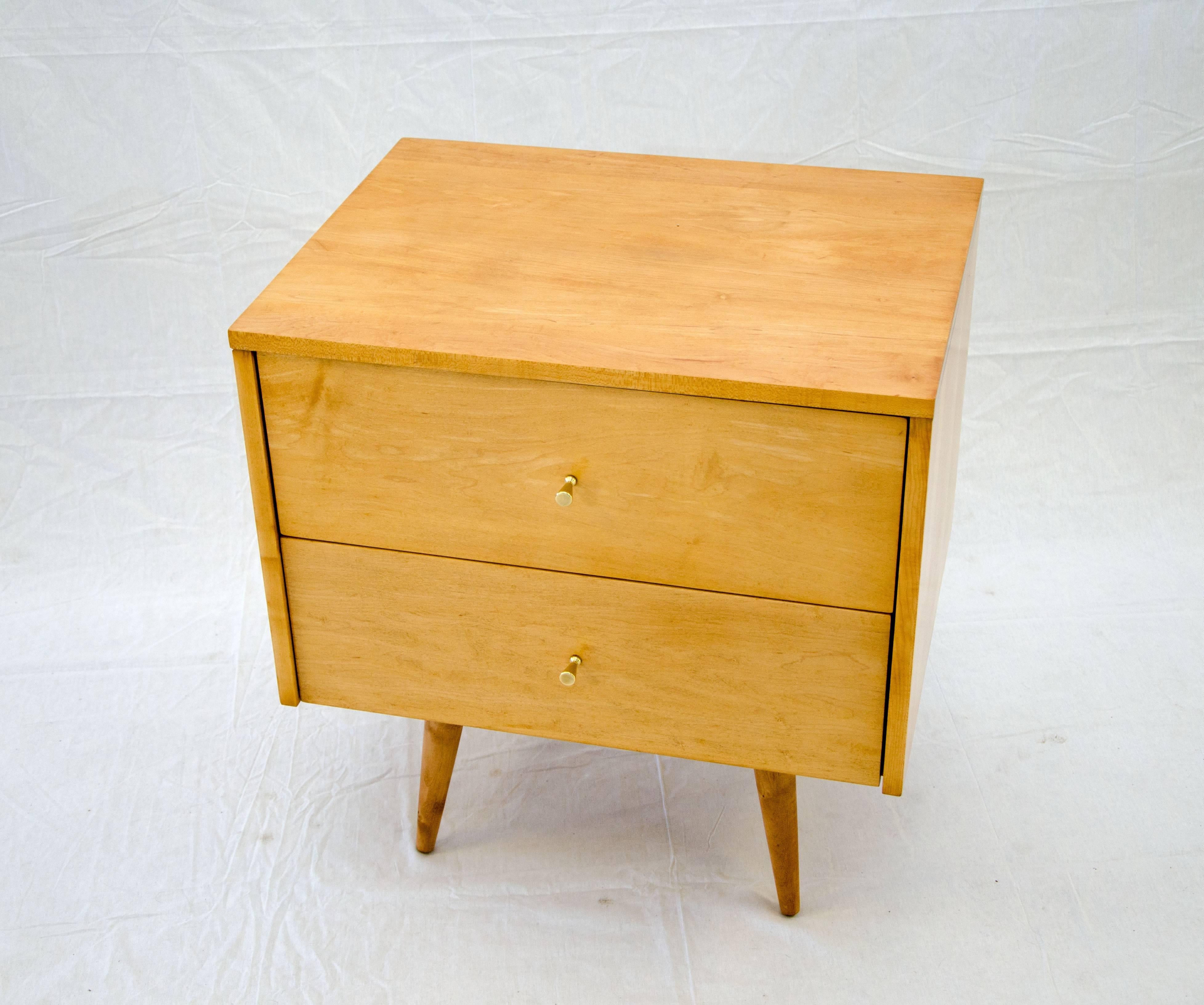 Paul McCobb two-drawer cabinet designed for the Planner Group and manufactured by the Winchendon Furniture Co in solid birch on angular tapered legs, which are 9 1/2
