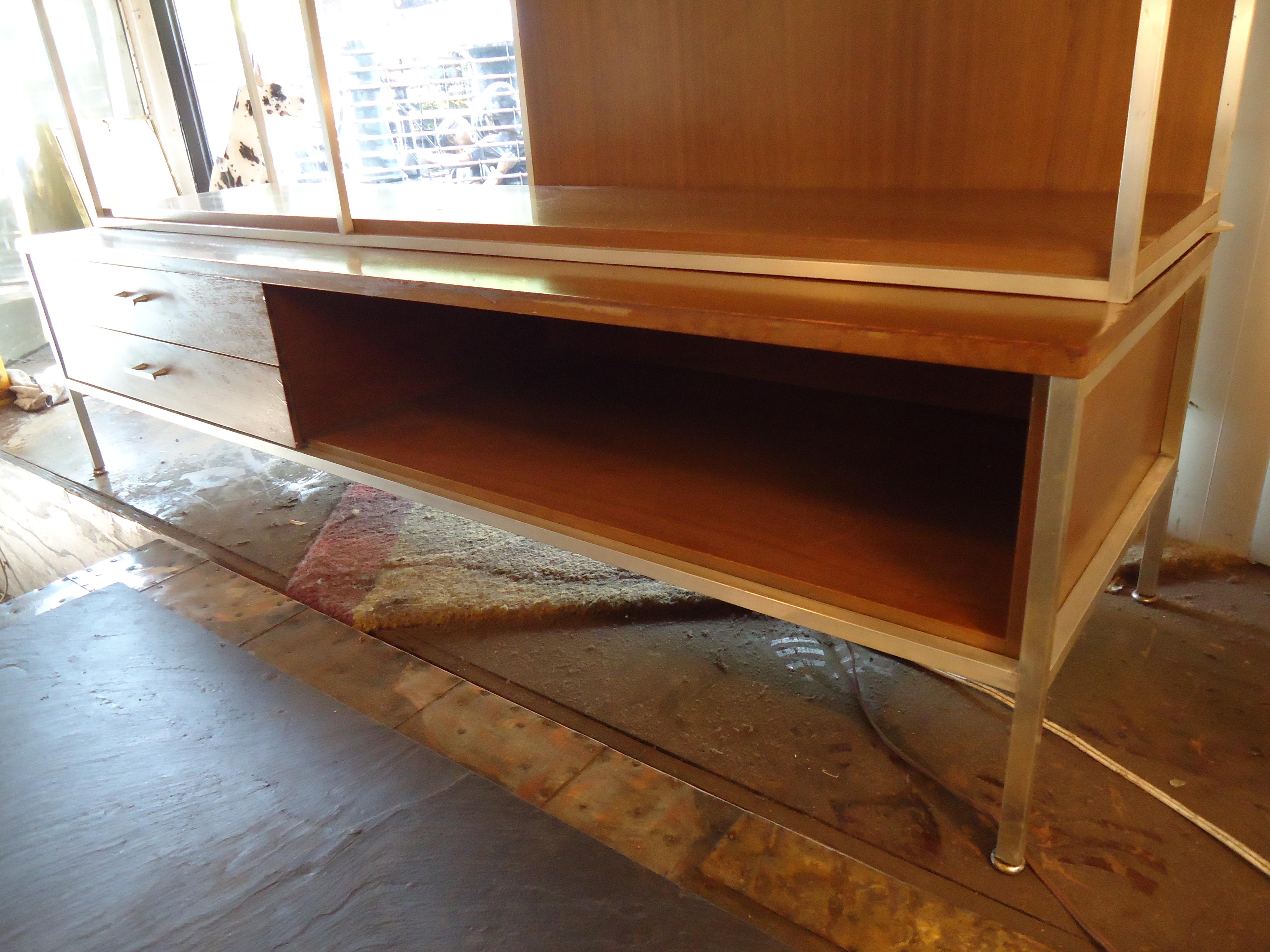 Mid-Century Modern two-piece bookcase with ample storage. Mahogany grain and chrome trim.
Base is 18