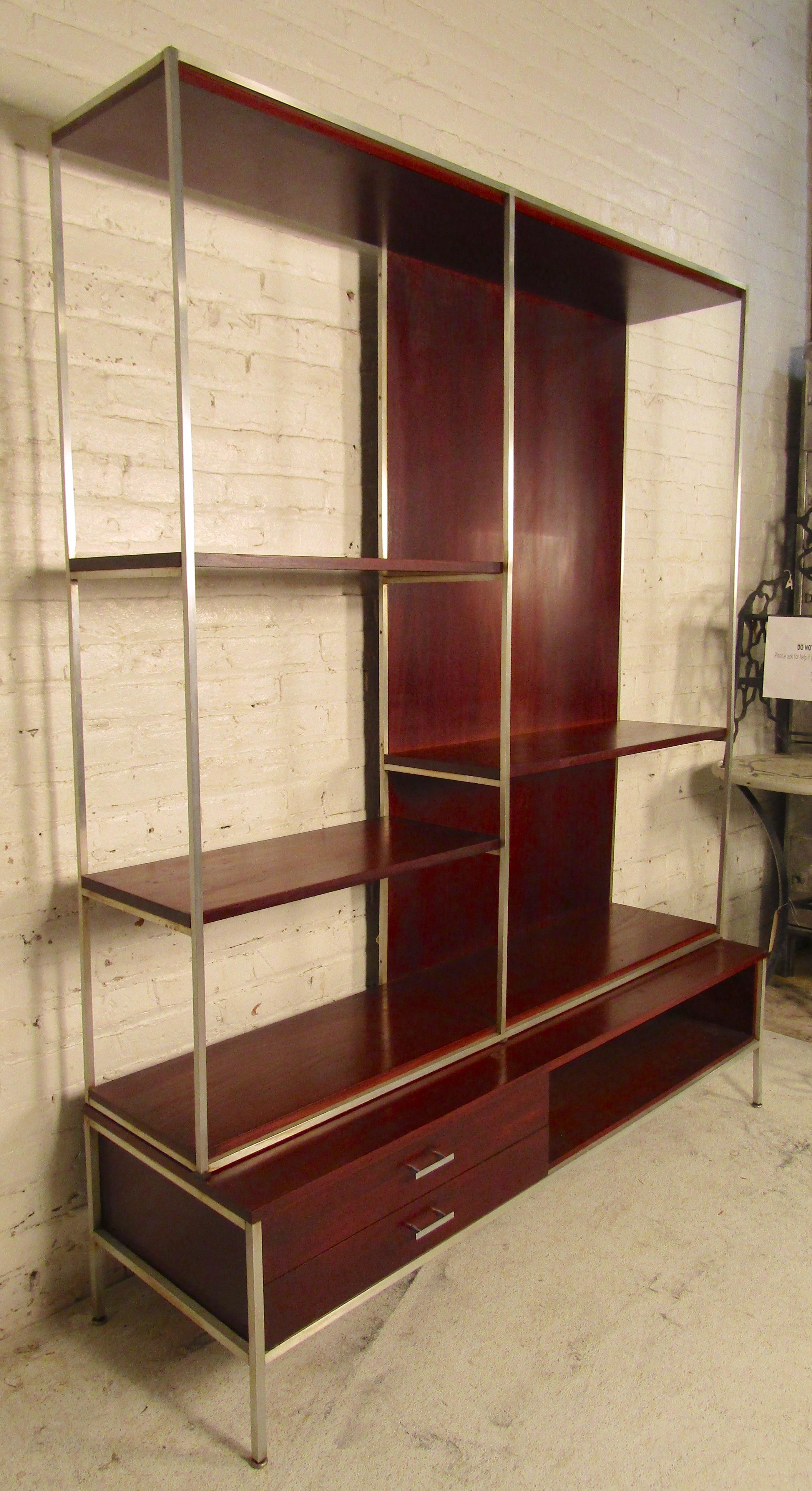 Two-piece bookcase by Paul McCobb for his Calvin collection. Rich mahogany color with chrome accenting frame and handles.
Measures: H 31.5 in. x W 54 in. x D 21 in.