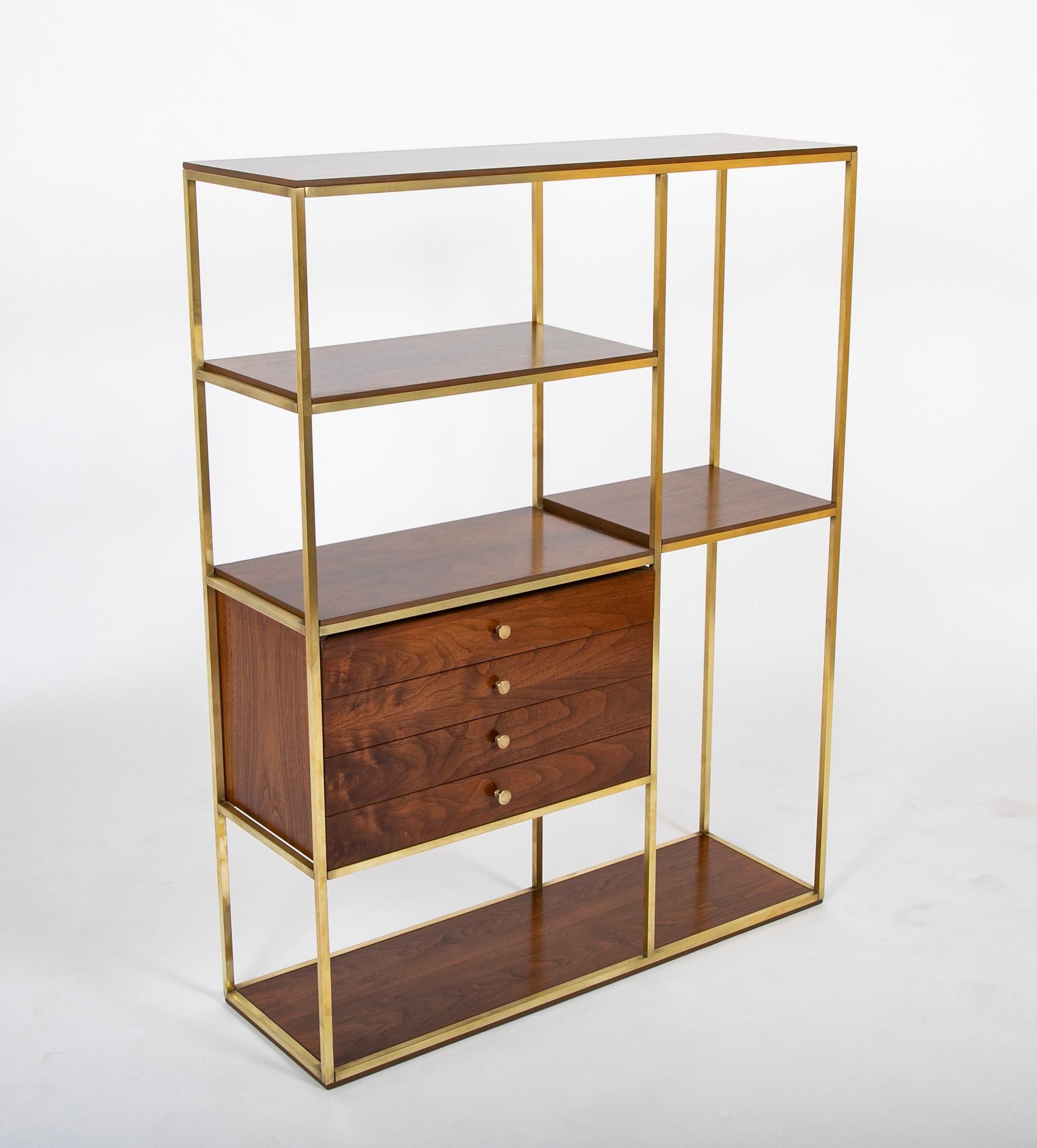 A Paul McCobb walnut and brass bookcase having four drawers. 

USA.

Mid 20th Century.