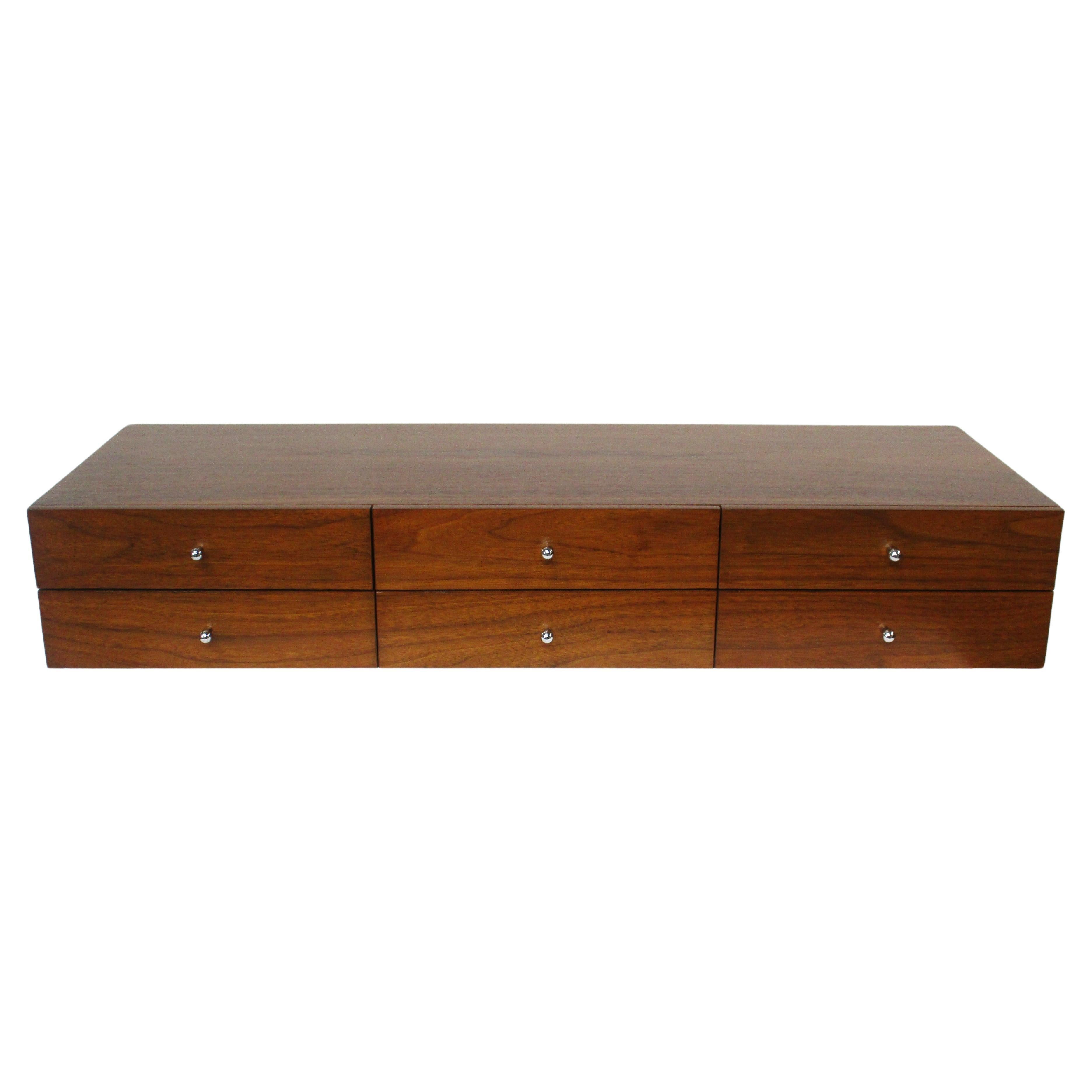 A very nice six drawer jewelry / watch box with sculptural chromed tear drop styled pulls . Crafted in beautiful well grained walnut including the backside with book matched front drawers by H. Sacks &  Sons from their Connoisseur Collection . One