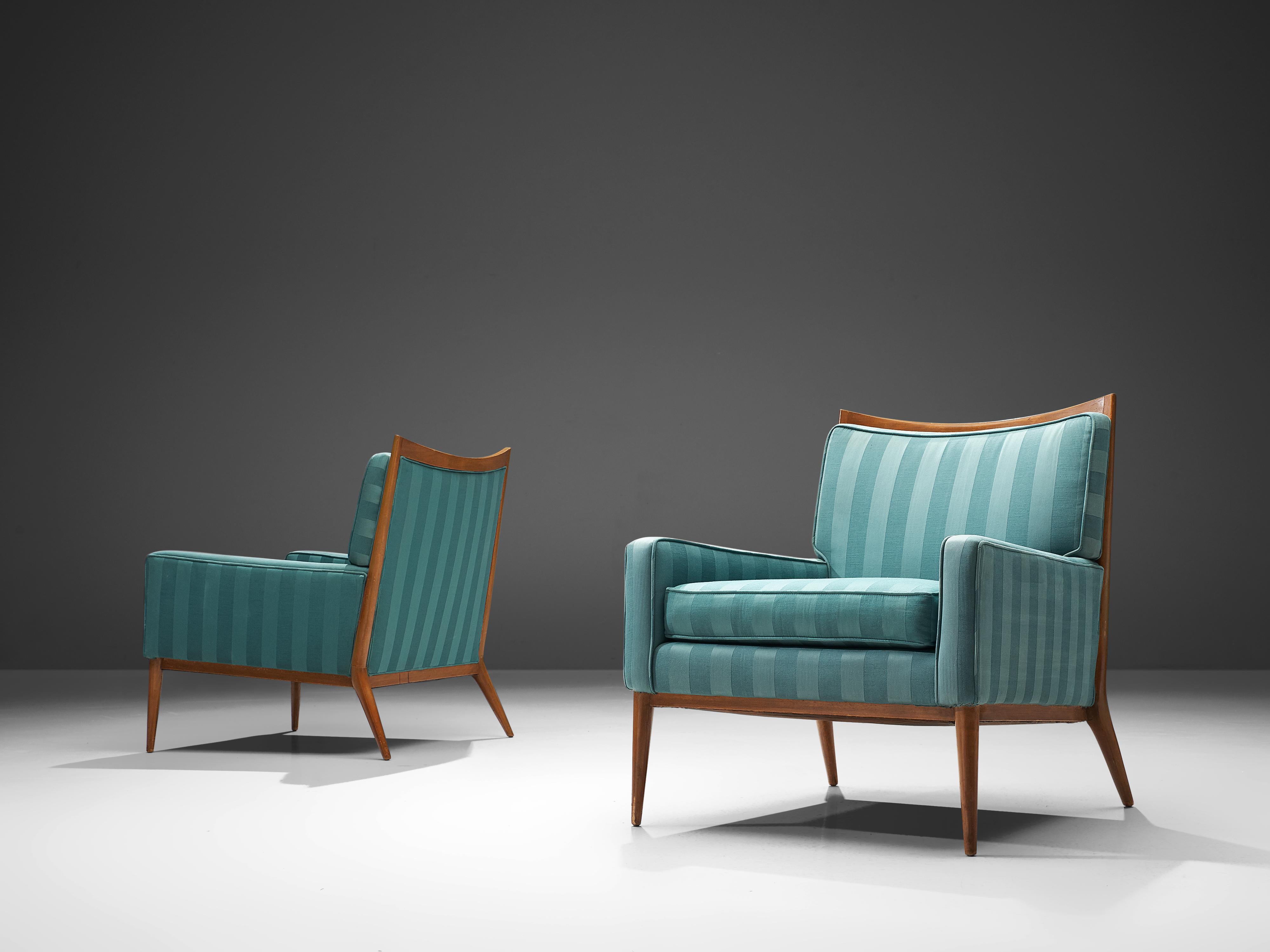 Paul McCobb for Directional Designs, lounge chair model 1322, walnut and blue fabric, 1950s. 

This pair of lounge chairs is designed by Paul McCobb. The quintessential design features of McCobb's furniture is clearly visible in this set such as