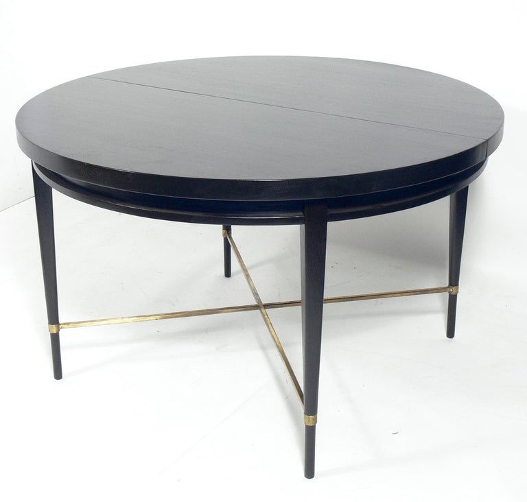 Paul McCobb X-base modern dining table, American, circa 1950s. This table has been refinished in an ultra-deep brown lacquer. This table does not have any leaves.