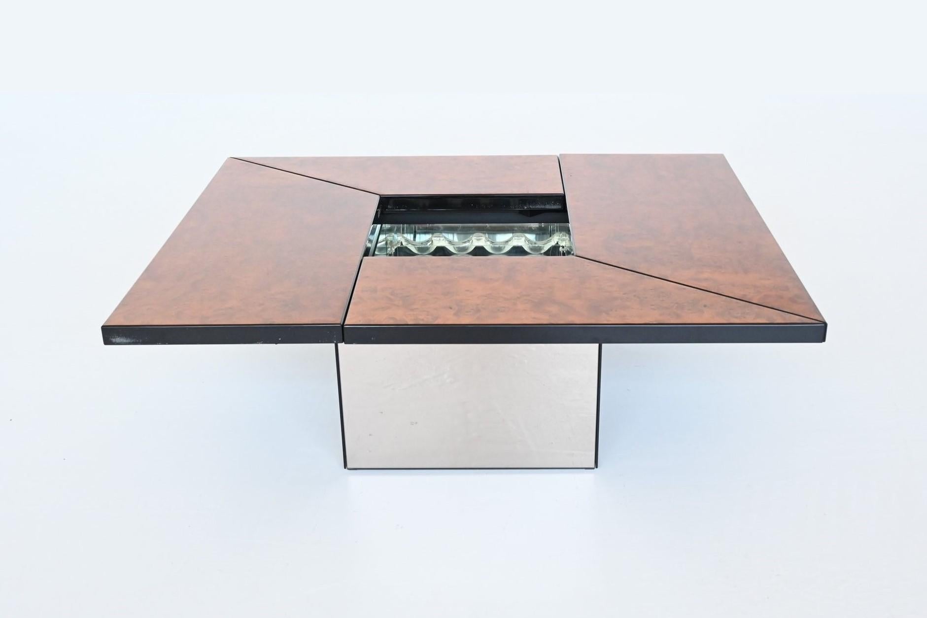 Super sophisticated stunning coffee table designed and manufactured by Paul Michel, France, 1970. This metamorphic coffee table is cleverly designed and slides smoothly open to reveal a mirrored spacious looking dry bar compartment, perfect spot to