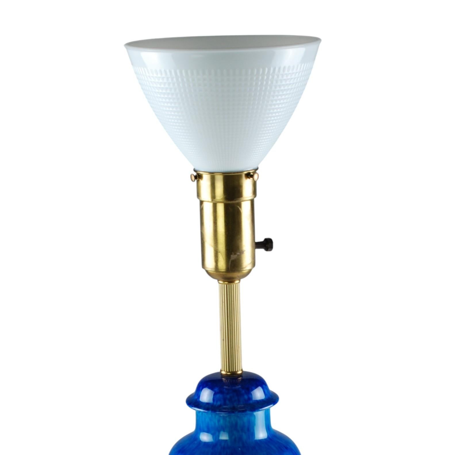 This Art Deco era porcelain torchiere table lamp was designed by Paul Milet (1870-1950) for Sèvres and comes complete with its original glass diffuser shade. The body of the lamp has been finished in a rich azure/sapphire jewel-toned glaze and is