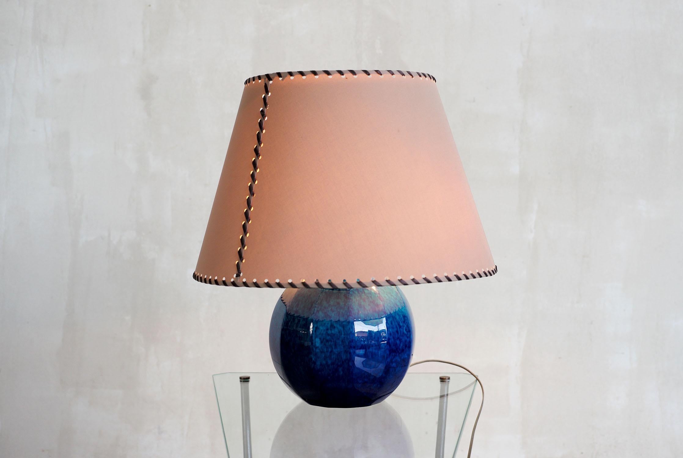 Speckled blue ceramic living room lamp by Paul Milet, Sèvres 1930. The laced fabric lampshade rests on the upper reflector, the three lights are independent, controlled by socket switches.
Dimensions of lamp base alone: D 25/H 49 cm
Signed under