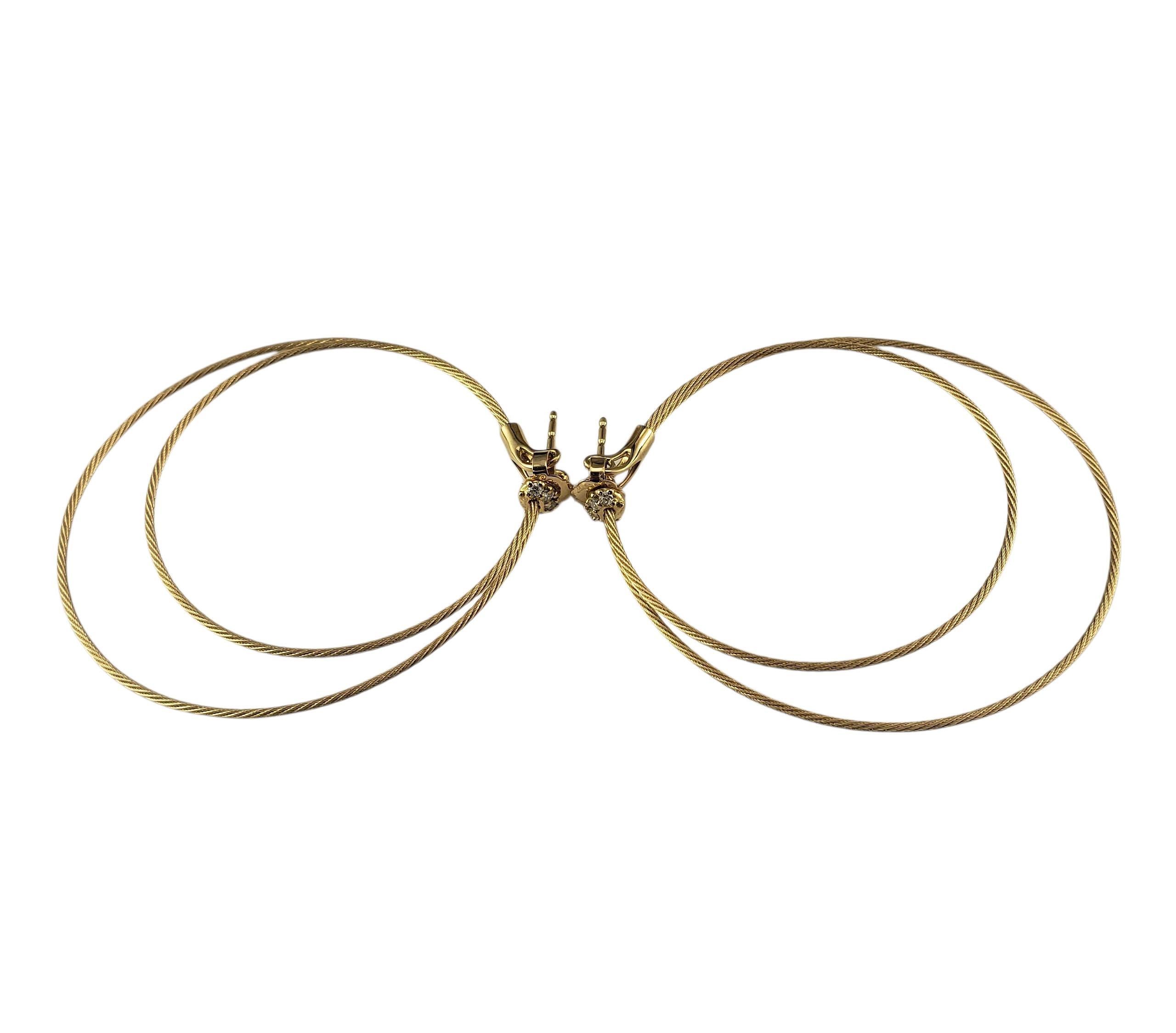 Paul Morelli 18K Yellow Gold and Diamond Double Unity Hoop Earrings-

Elegant and understated, these earrings feature two concentric twisted gold wire hoops crafted in 18K yellow gold. A cluster of 4 diamonds unites the flexible strands, signifying