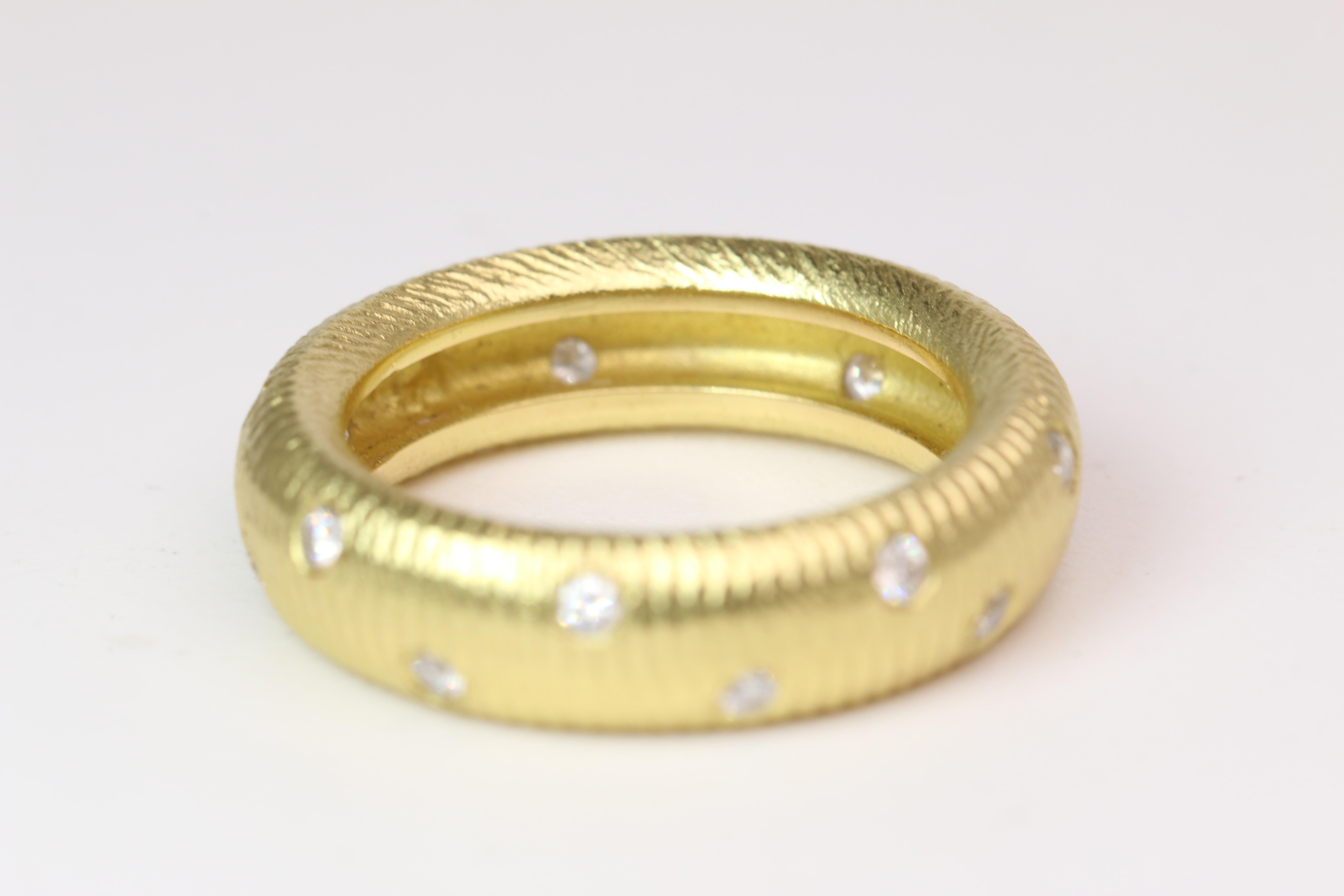 This stunning band features a staple design language from Paul Morelli. Sized to a 6.5 this ring cast in 18k yellow gold features 16 round diamonds and weighs a total of 7.6g.