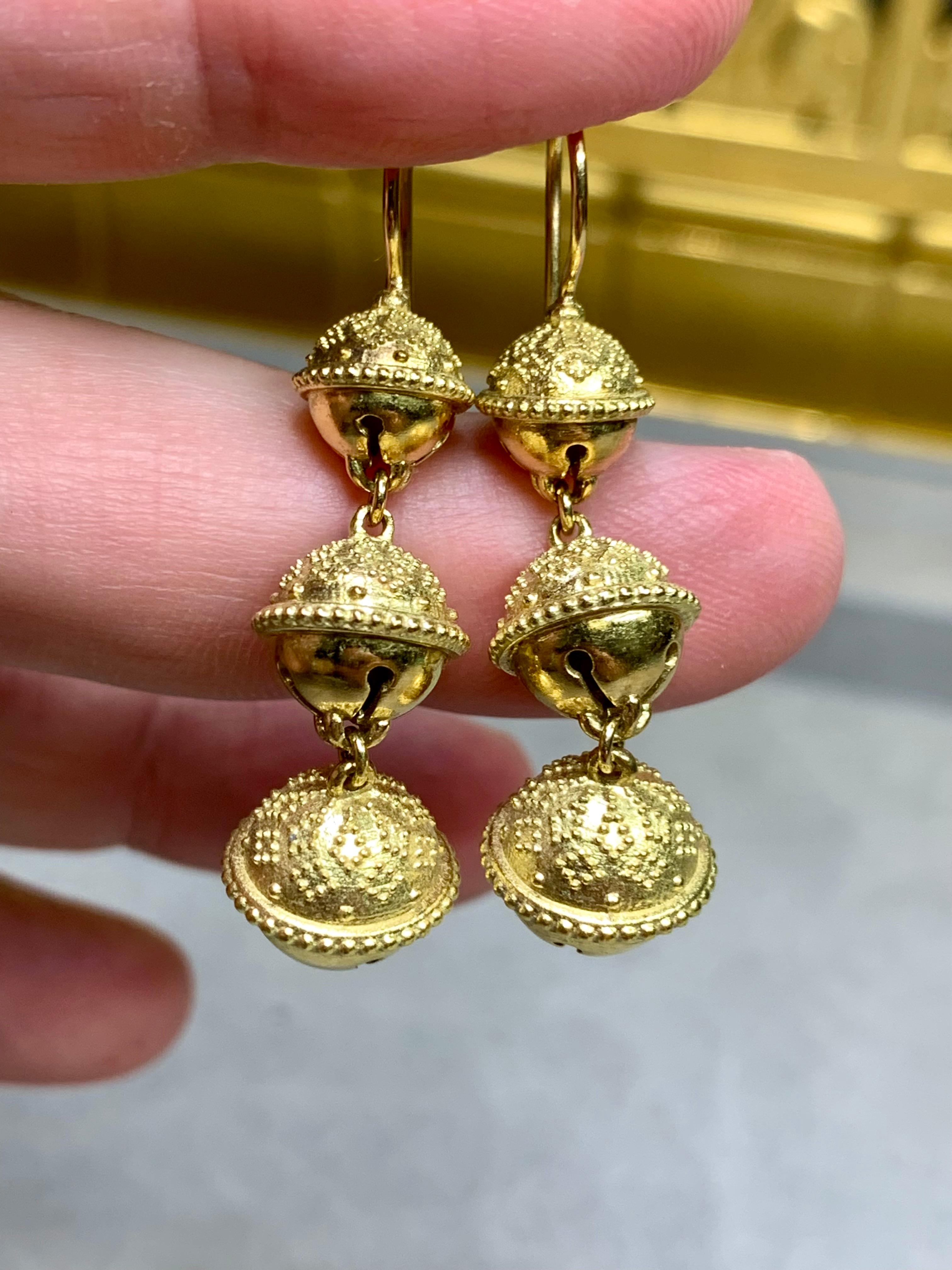 Earrings by Paul Morelli from their Meditation collection. These beautifully worked triple - bell

earrings are crafted in 18K yellow gold and detailed with Etruscan revival milgraining throughout and have their traditional hook back