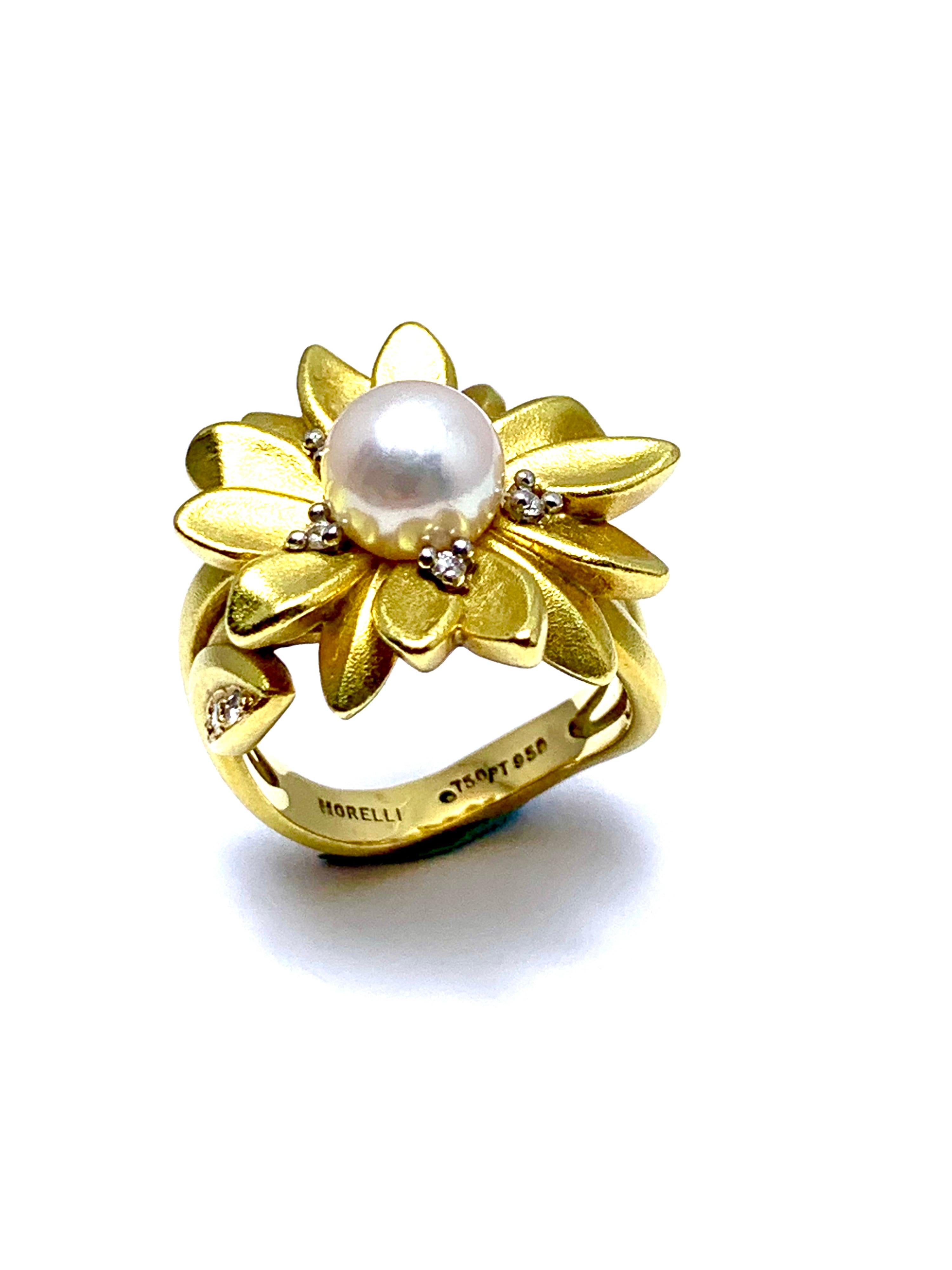 A gorgeous Paul Morelli cultured Pearl and Diamond daisy flower ring.  The center set pearl is 7.70mm, set with five diamonds around flower top of the ring, and six more diamonds set in the leaves of the stem shank of the ring.  The diamonds have a