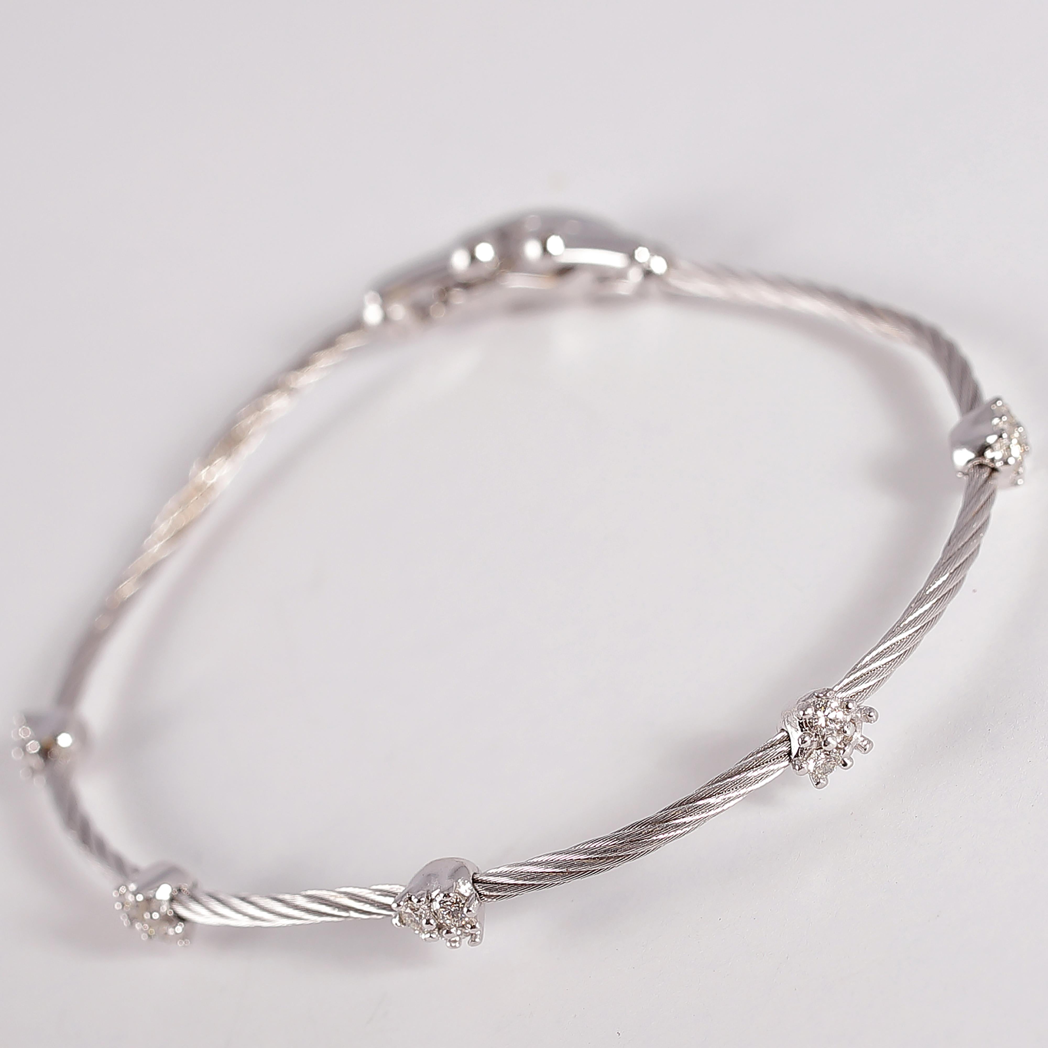 Wear one or several for a nice crisp look! Composed of 18 karat white gold, this bracelet features clusters of diamonds, with an approximate total weight of 0.35 carats.