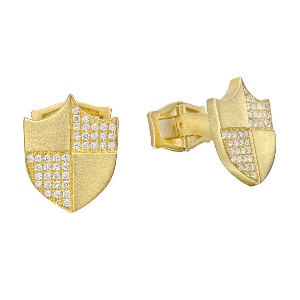 Shield-shaped cufflinks in 18k yellow gold with pavé diamonds and hinged leverbacks. Round-cut diamonds weighing 0.70 total carats. Designed by Paul Morelli.