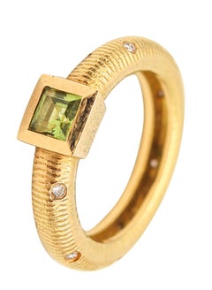 PAUL MORELLI Bague-bandeau en or 18Kt avec diamants et péridot vert vif