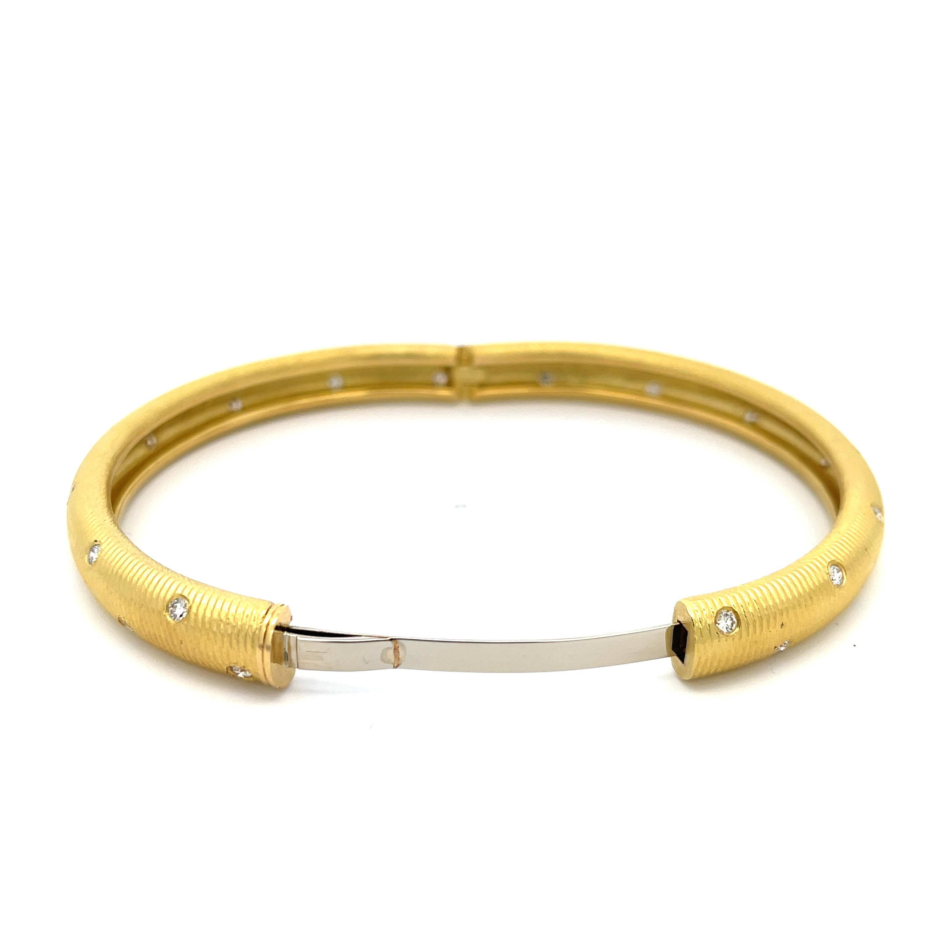 Paul Morelli Wide Ribbed Diamond Bangle in 18K Yellow Gold. The bangle features 30 brilliant round cut diamonds and weighs 34.28 grams
7