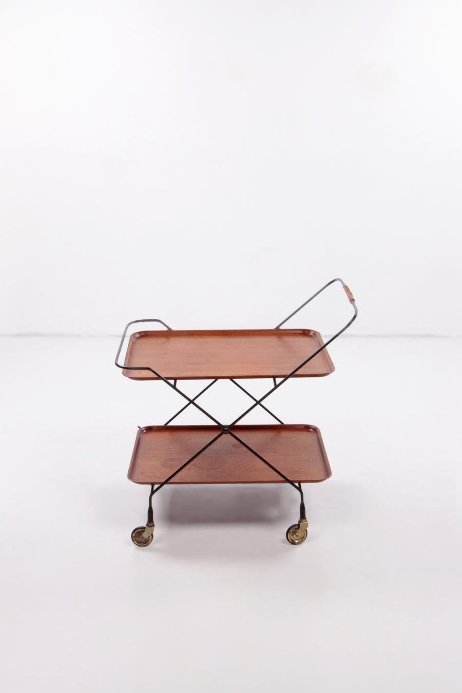 Paul Nail Vintage Trolley Made by Jie Gantofta,1960 Sweden

This stylish vintage serving trolley was designed in the 1960s by the Swedish designer Paul Nagel and produced by JIE Gantofta. The cart, which can also serve as a bar trolley, is made of