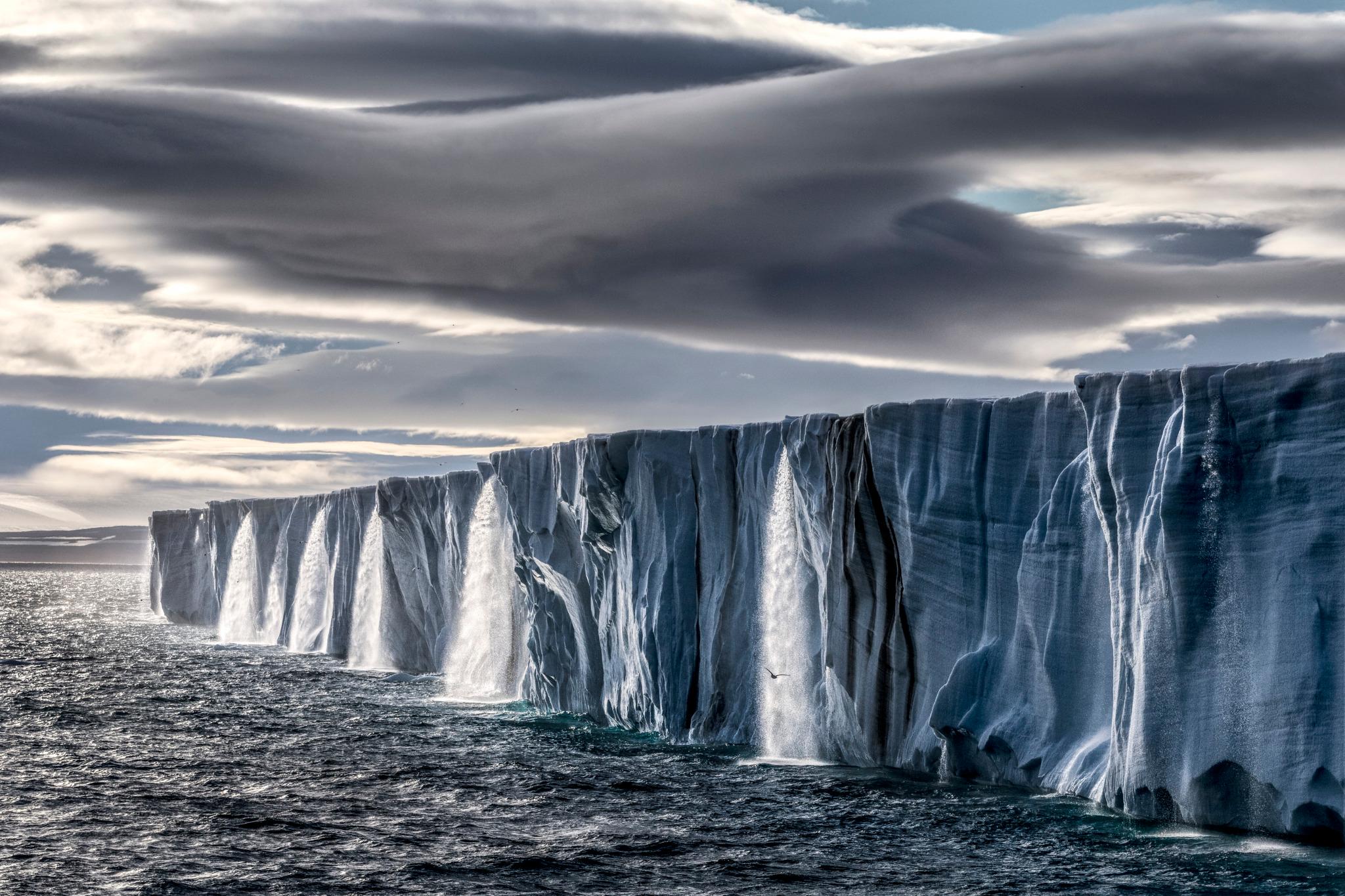 Ice Waterfall
Svalbard, Norway, 2014

31 × 46.5 in / 78.7 × 118.1 cm / Edition of 15

"Arctic waterfalls sprout from the Nordaustlandet ice cap as it gushes high volumes of meltwater – a striking reminder of this icy ecosystem's fragility. Even