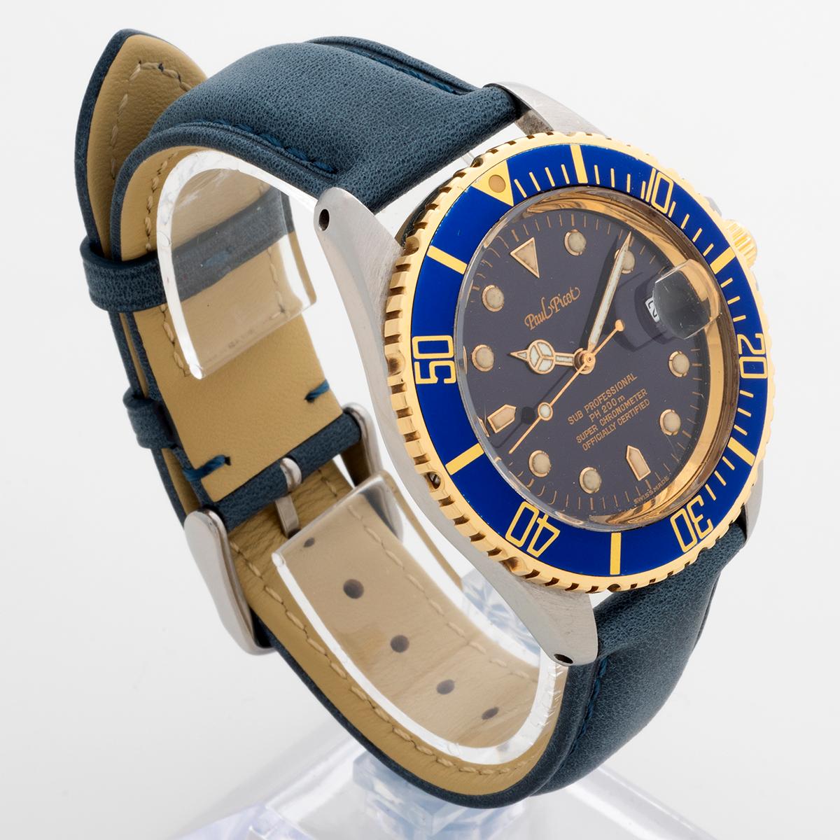Our rare vintage Paul Picot Sub Professional / Paul Mariner, reference 211-38-5000, features a stainless steel 39mm case (42mm to crown guard), with blue nipple indices dial and blue bezel insert in a 14k yellow gold rotating bezel. Powered by an