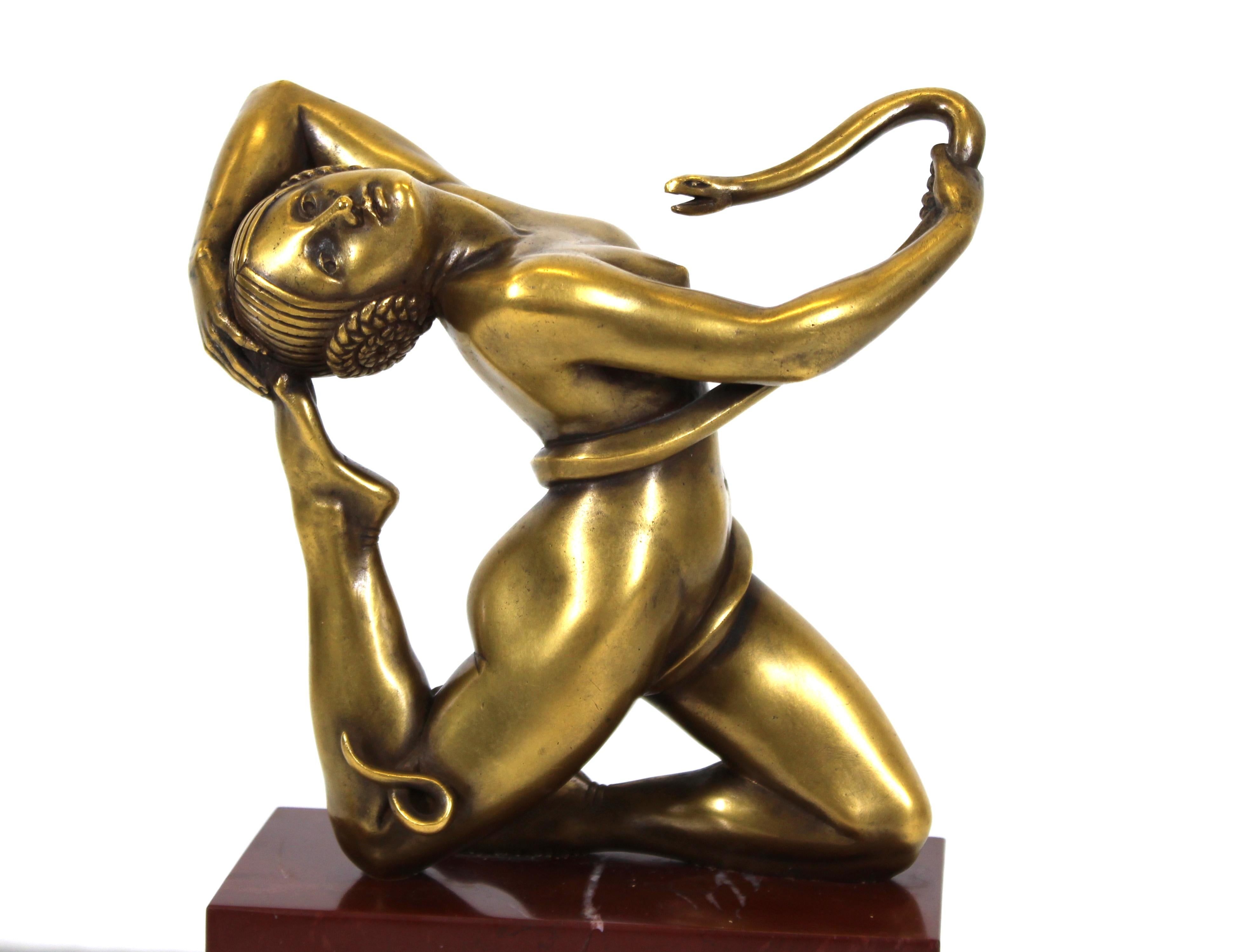 French Art Deco bronze tabletop sculpture of a snake charming nude woman mounted on a red veined marble base with incised Egyptian and Greek Revival elements. The piece is signed 'Paul Piel' and dated 1925 on the lower lip of the base. Partial old