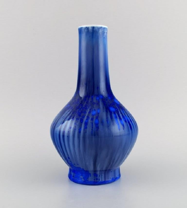 Paul Proschowsky (1893-1968) for Royal Copenhagen. 
Unique porcelain vase. Beautiful crystal glaze in shades of blue. 
Dated 1924.
Measures: 24 x 14.5 cm.
In excellent condition.
Signed and dated