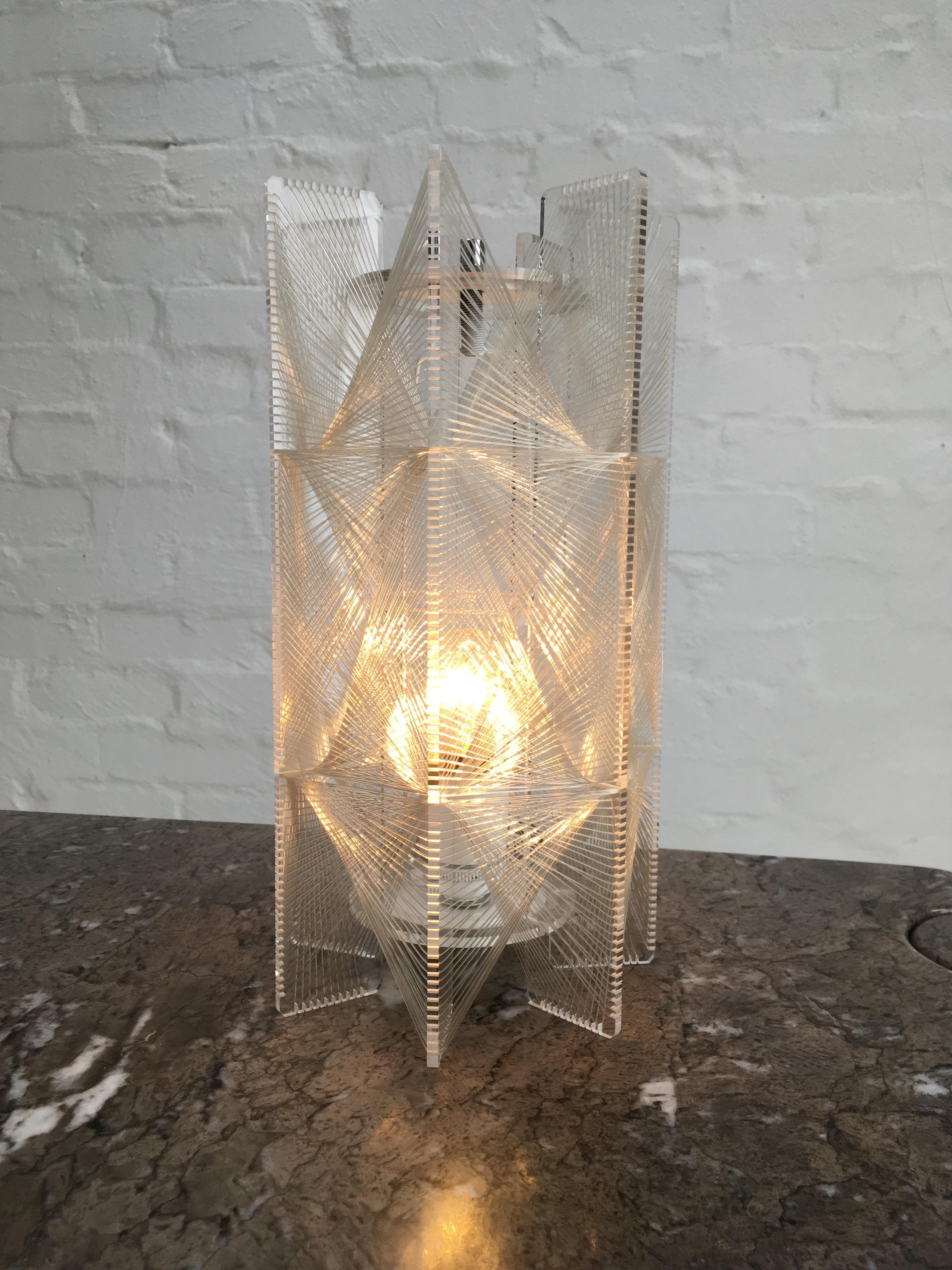 A rare table lamp by Paul Secon. His lights are more commonly found as pendants. 

It had lost is internal fixtures so we had our master craftsman make an appropriate white and chrome harp fixture for the interior, based on images of original Paul