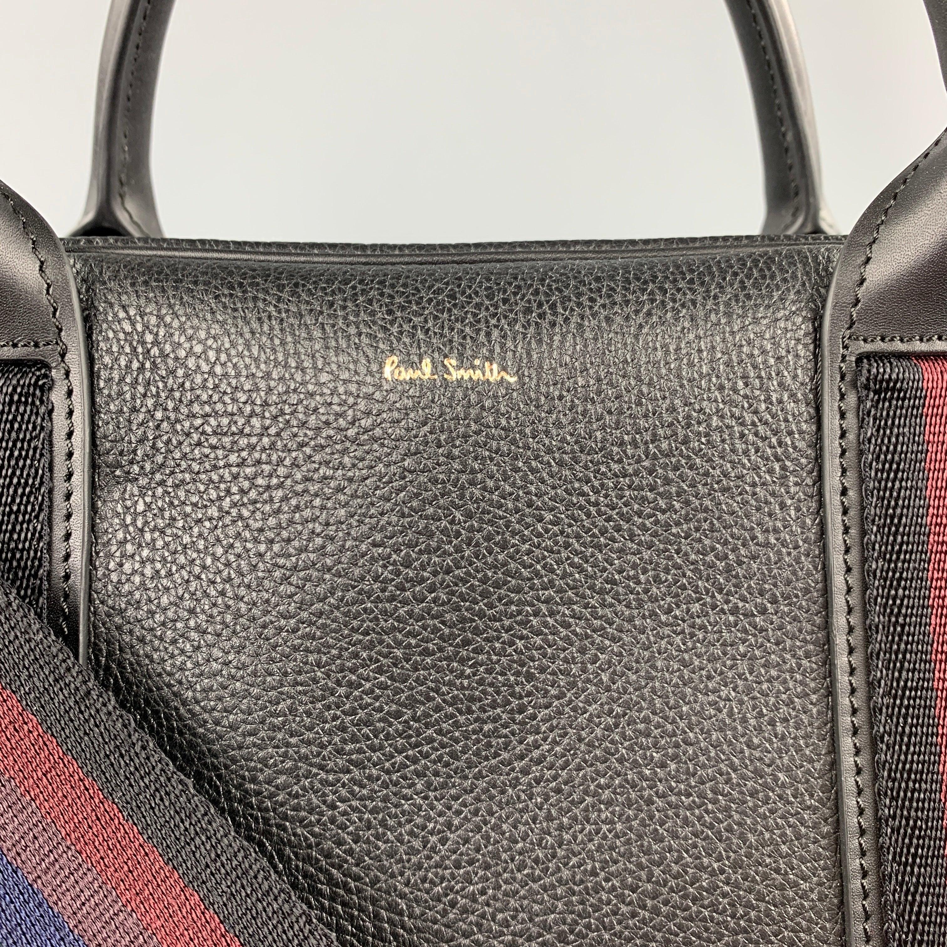 PAUL SMITH briefcase bag comes in a black pebble grain leather with a stripe trim featuring a shoulder strap, top handles, and a zipper closure.Very Good
Pre-Owned Condition. 

Measurements: 
  Length: 14 inches  Width: 5 inches  Height: 11 inches 