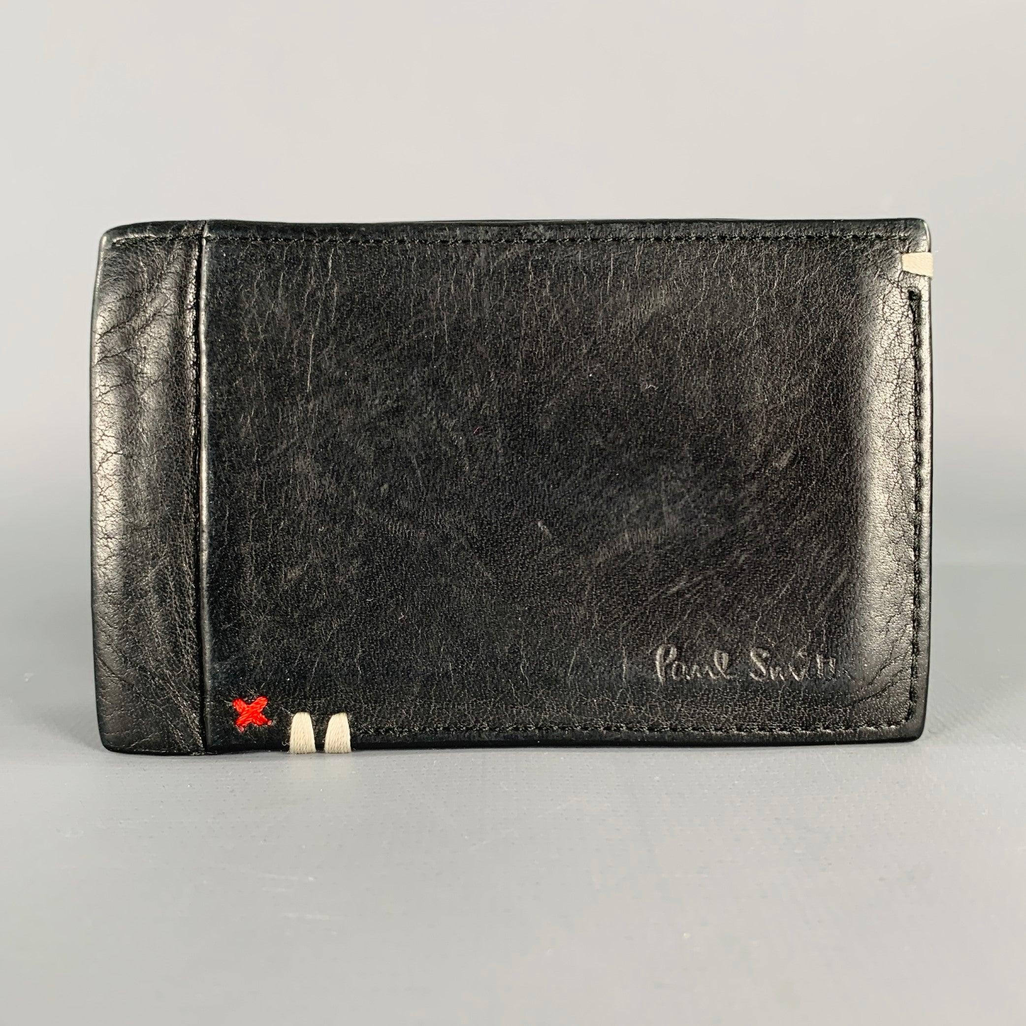 PAUL SMITH wallet
in a black leather featuring a cardholder style, contrasting red ID card holder lining, and red and white contrast stitch accents.Very Good Pre-Owned Condition. 

Measurements: 
  4 inches  x 2.5 inches 
  
  
 
Sui Generis