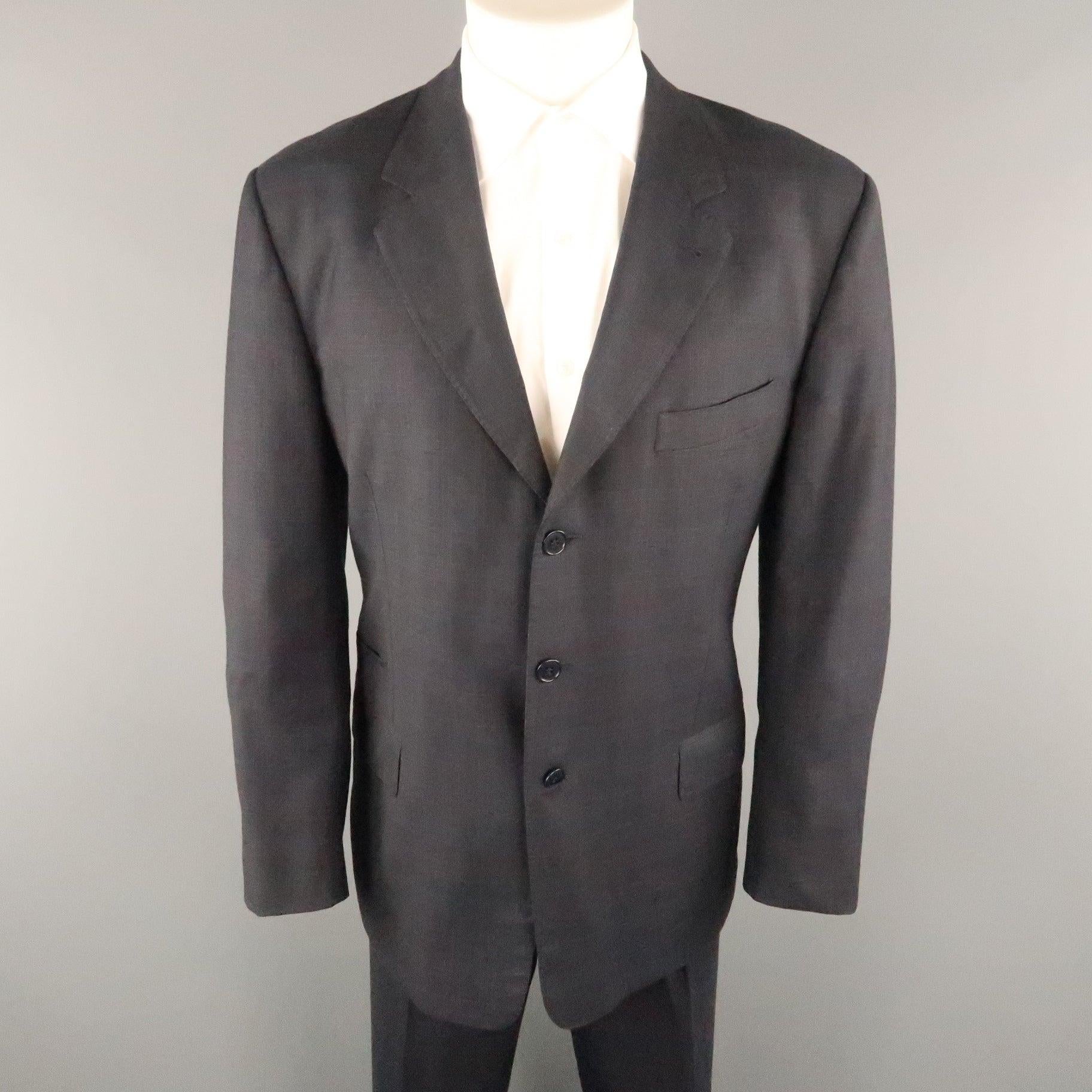 PAUL SMITH suit comes in a charcoal plaid wool featuring a notch lapel, three button closure, flap pockets, and a matching front flat style pant. Made in Italy. 
Excellent Pre-Owned Condition.
 

Marked:   IT 42
 

Measurements: 
 
