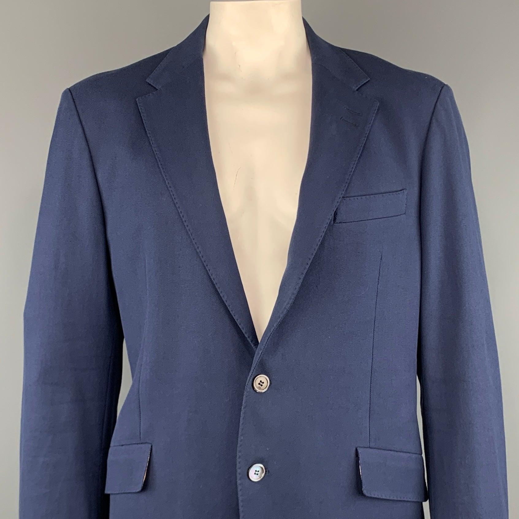 PAUL SMITH sport coat comes in a navy woven cotton with a notch lapel, stitching details, flap pockets, and a two button closure. Made in Italy.
Excellent
Pre-Owned Condition.  

Marked:   54 

Measurements: 
 
Shoulder: 19 inches 
Chest: 42 inches