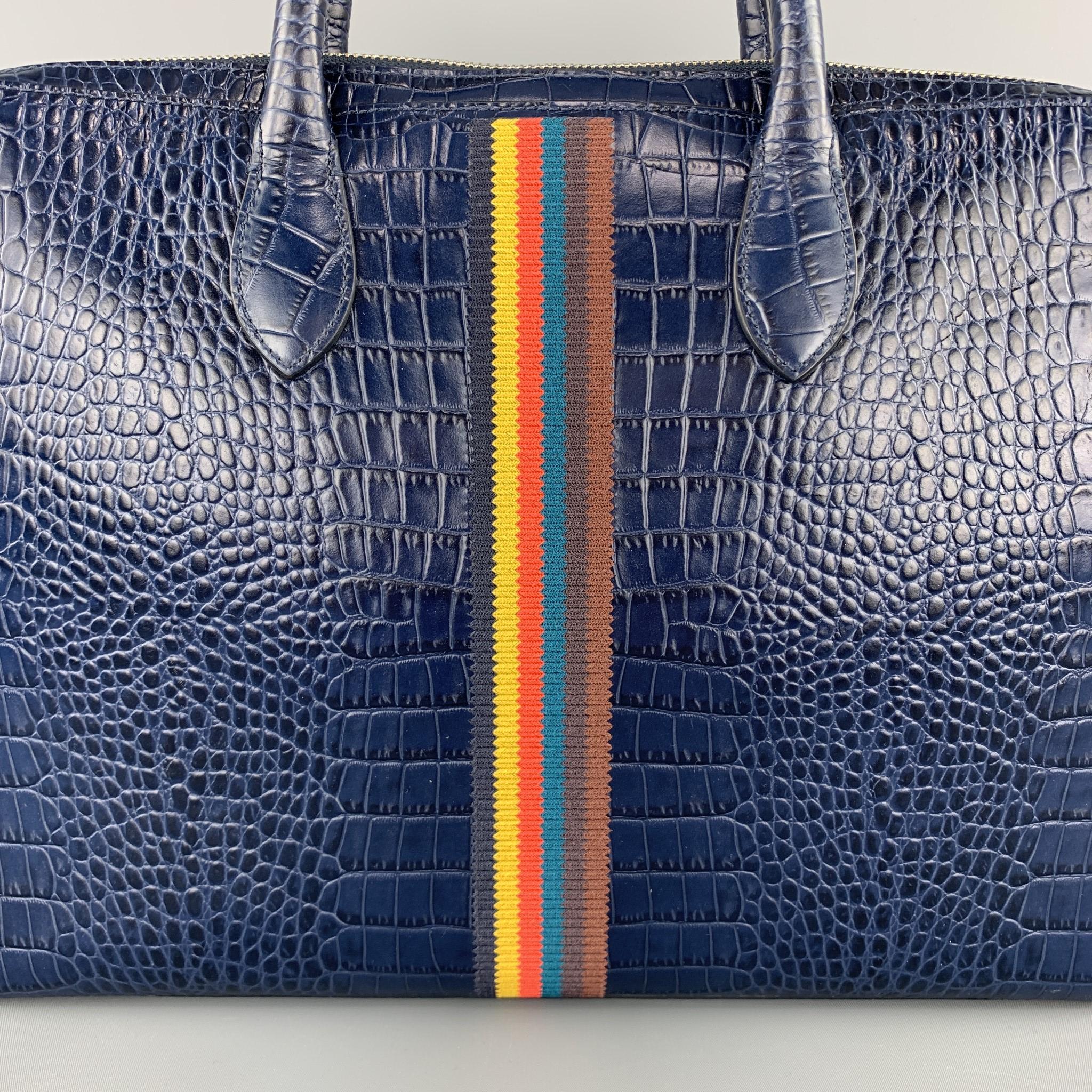 PAUL SMITH briefcase comes in navy blue alligator embossed leather with top handles, double zip top closure, multi color ribbon stripes, and detachable strap. 

Excellent Pre-Owned Condition.

Measurements:

Length: 15 in.
Width: 2 in.
Height: 11 in.