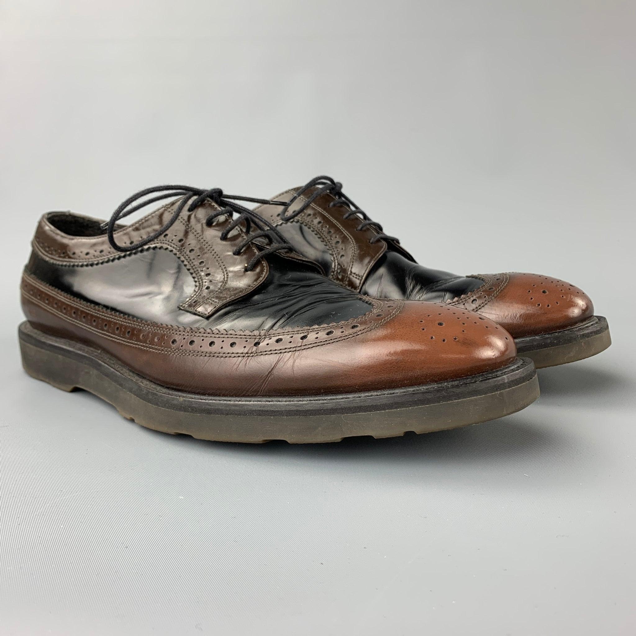 PAUL SMITH shoes comes in a black & brown perforated leather featuring a wingtip style, rubber sole, and a lace up closure.
Good
Pre-Owned Condition. 

Marked:   J119 EU 43.5Outsole:12.5 inches  x 4.5 inches 
  
  
 
Reference: 106568
Category: Lace