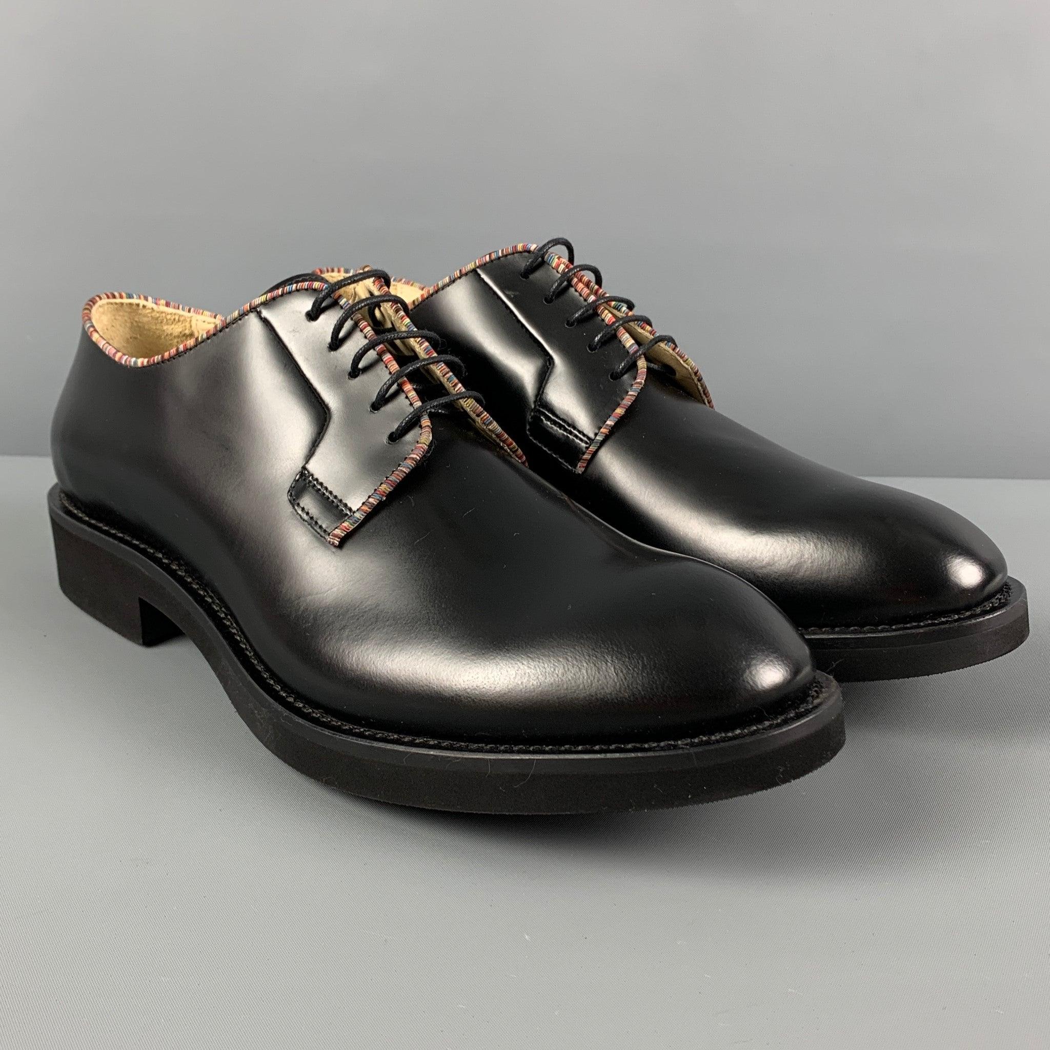 PAUL SMITH shoes comes in a black leather featuring a classic style, striped trim, and a lace up closure. Includes box. Made in Italy.
Excellent
Pre-Owned Condition. 

Marked:   WSL04 10 44Outsole: 13 inches  x 4.5 inches 
  
  
 
Reference:
