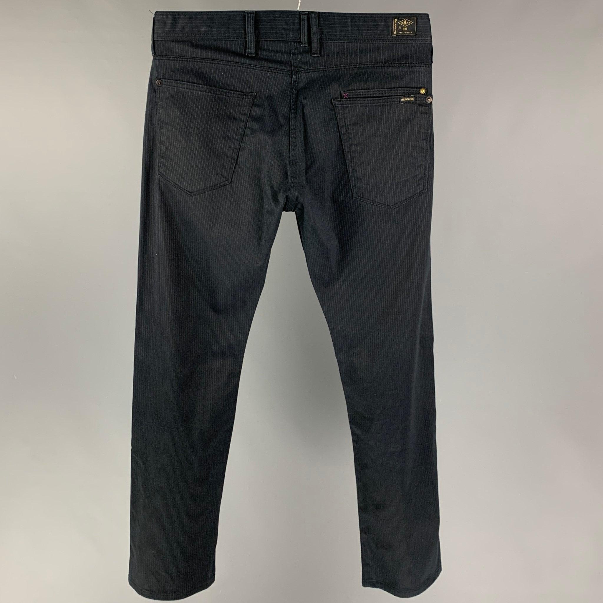 PAUL SMITH pants comes in a navy pinstripe cotton blend featuring a jean cut style and a button fly closure.
Very Good
Pre-Owned Condition. 

Marked:   30 

Measurements: 
  Waist: 30 inches  Rise: 11 inches  Inseam: 30 inches 
  
  
 
Reference: