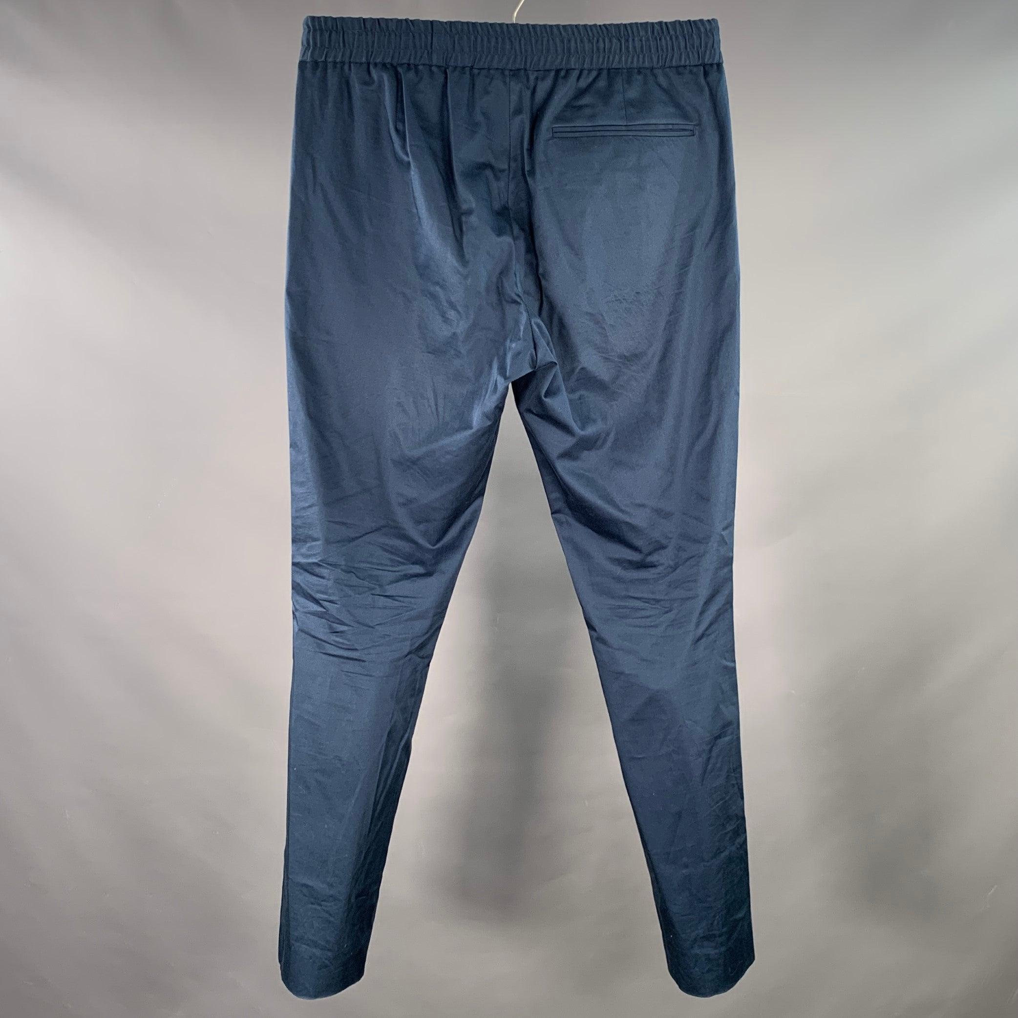 PAUL SMITH casual pants
in a navy woven fabric featuring a flat front, tapered leg, and drawstring waistband with zip fly closure. Made in Portugal.Excellent Pre-Owned Condition. 

Marked:   32 

Measurements: 
  Waist: 32 - 37 inches Rise: 10