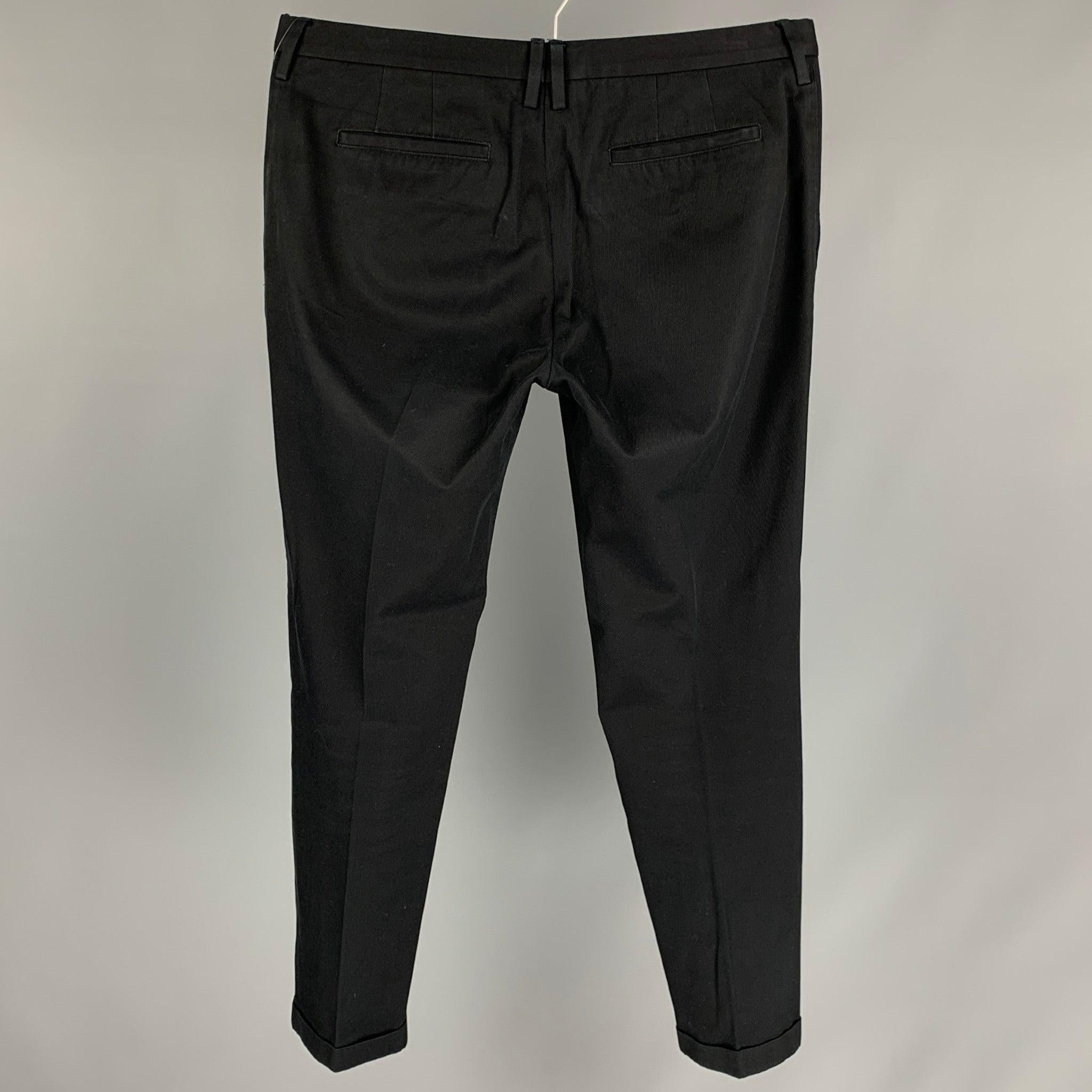 PAUL SMITH casual pants comes in a black cotton featuring a chino style, cuffed leg, and a zip fly closure. Made in Portugal. Very Good
Pre-Owned Condition. 

Marked:   36 

Measurements: 
  Waist: 34 inches  Rise: 10.5 inches  Inseam: 28 inches 
 