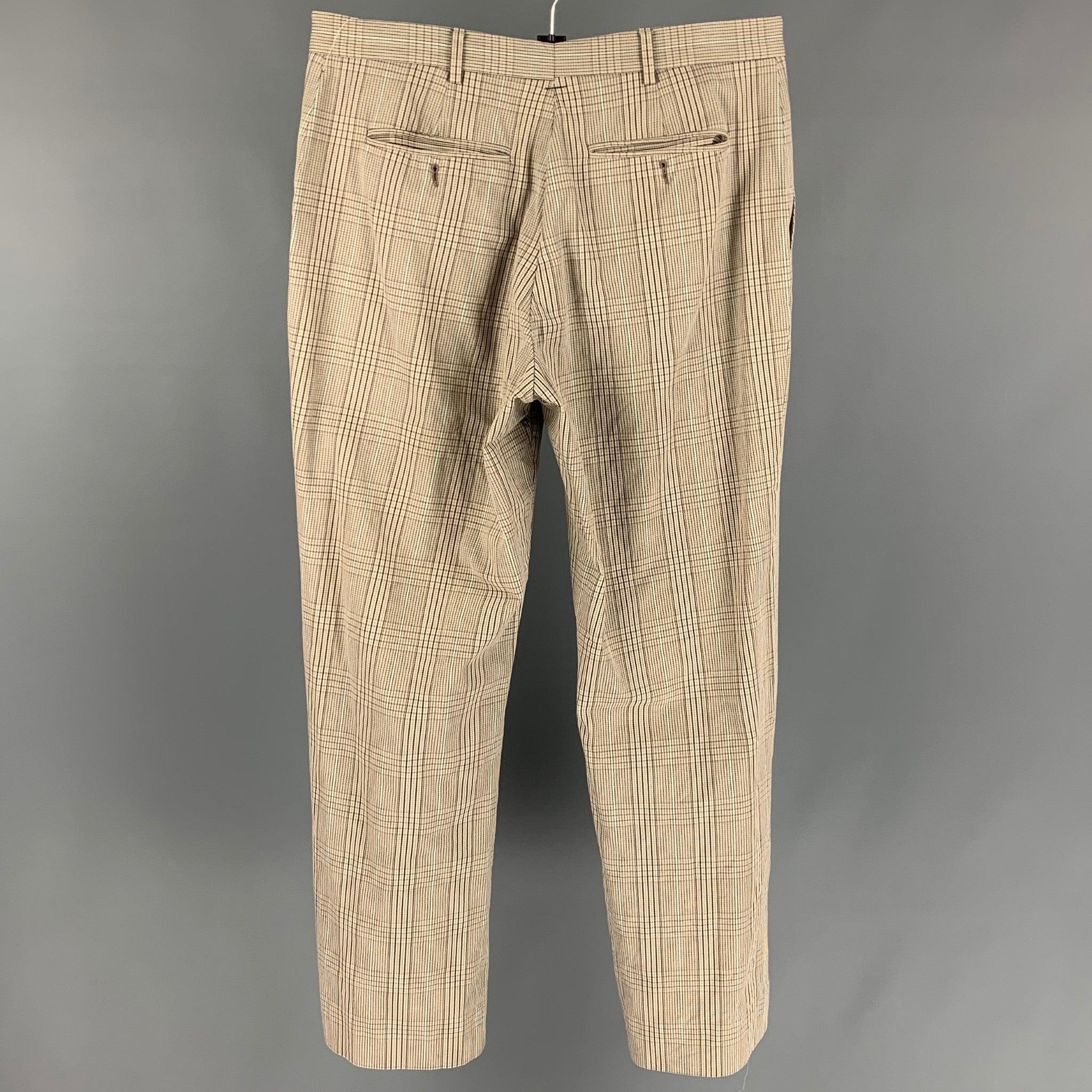 PAUL SMITH dress pants comes in a taupe & brown plaid cotton featuring a flat front, front tab, and a zip fly closure.
Very Good
Pre-Owned Condition. 

Marked:   36 

Measurements: 
  Waist: 32 inches  Rise: 11.5 inches  Inseam: 30 inches 
  
  
