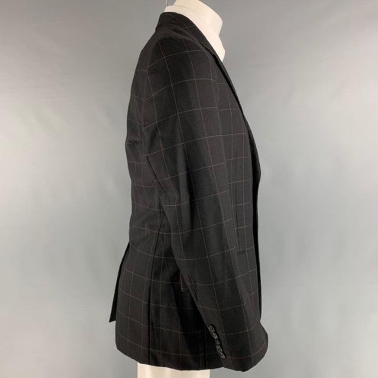 PAUL SMITH sport coat comes in black and brown wool cashmere window pane woven material featuring a notch lapel, single breasted, two button front, and single vented back. Made in Italy.Excellent Pre-Owned Condition. 

Marked:   40 

Measurements: 
