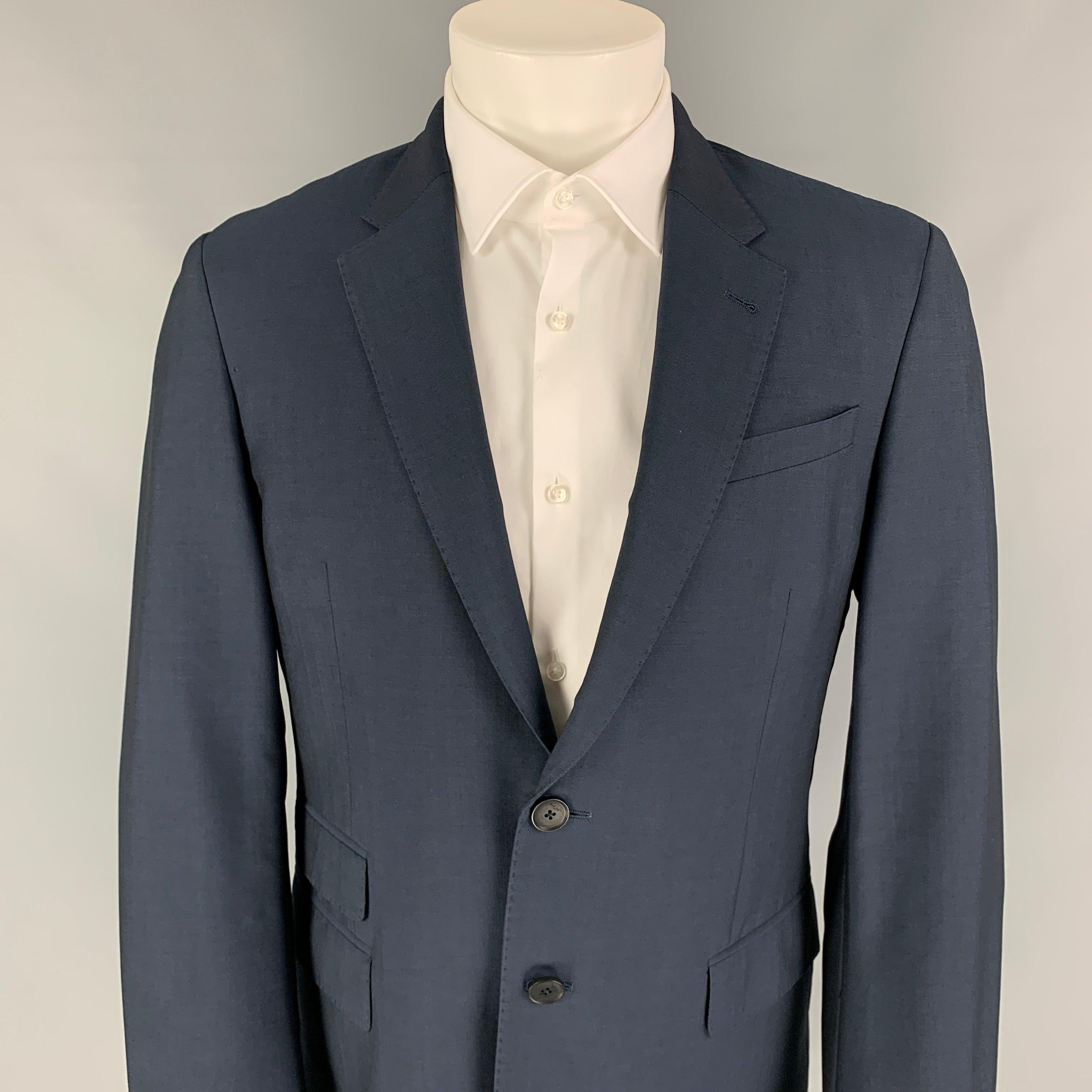 PAUL SMITH sport coat comes in a steel blue wool with a full liner featuring a notch lapel, flap pockets, single back vent, and a double button closure. Made in Italy.
Excellent
Pre-Owned Condition. 

Marked:   R 40  

Measurements: 
 
Shoulder: 18