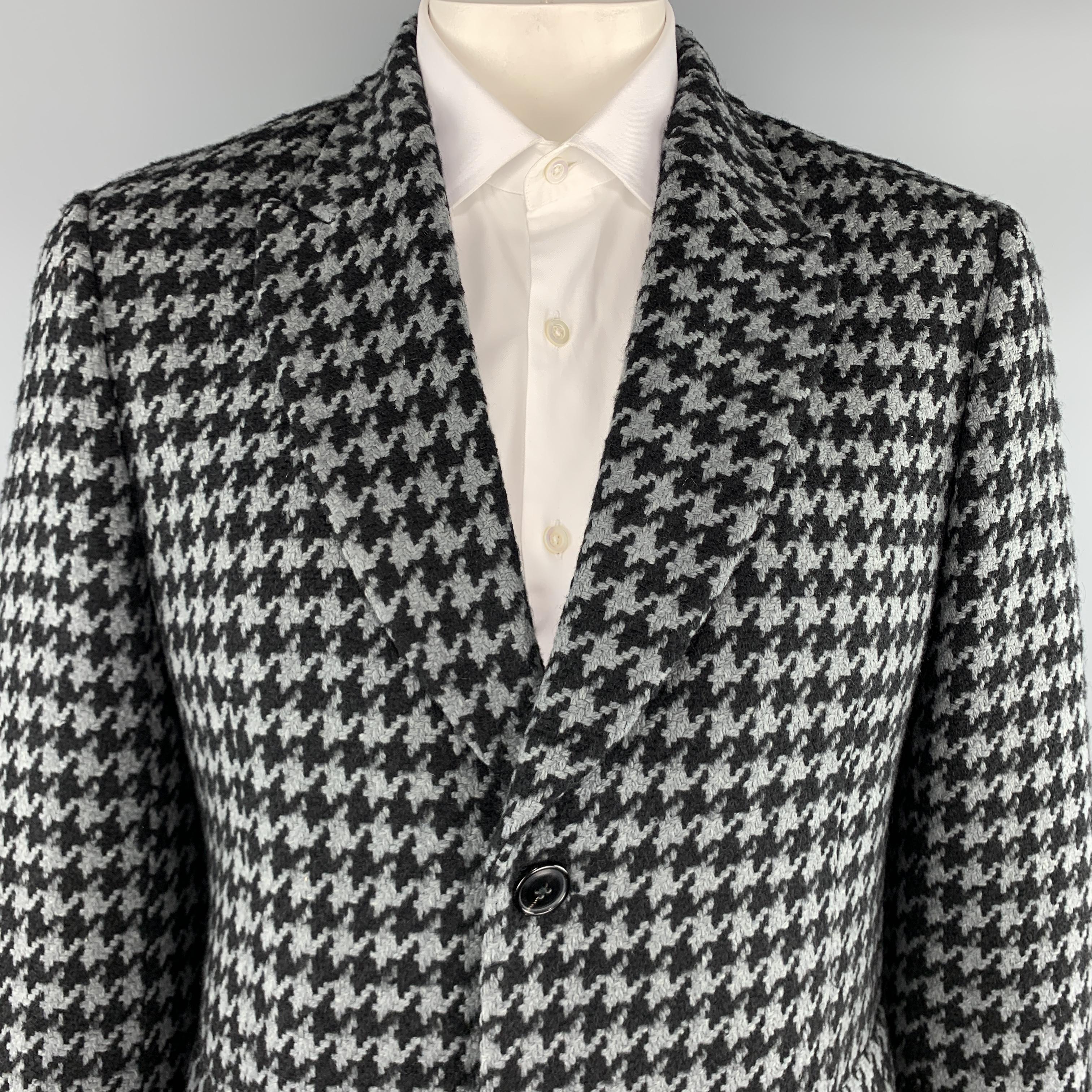 PAUL SMITH coat comes in a muted teal and black houndstooth wool mohair blend tweed with a peak lapel, single breasted three button front, and flap pockets. Made in Italy.

Excellent Pre-Owned Condition.
Marked: 42 R

Measurements:

Shoulder: 18.5
