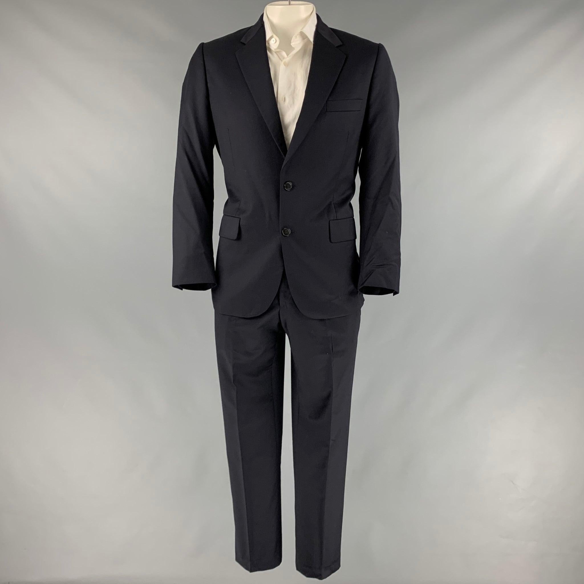 PAUL SMITH suit
in a navy wool cashmere with a full liner and includes a single breasted, double button sport coat with notch lapel and matching flat front trousers. Made in Italy.Very Good Pre-Owned Condition. Minor mark on back. 

Marked:   42R