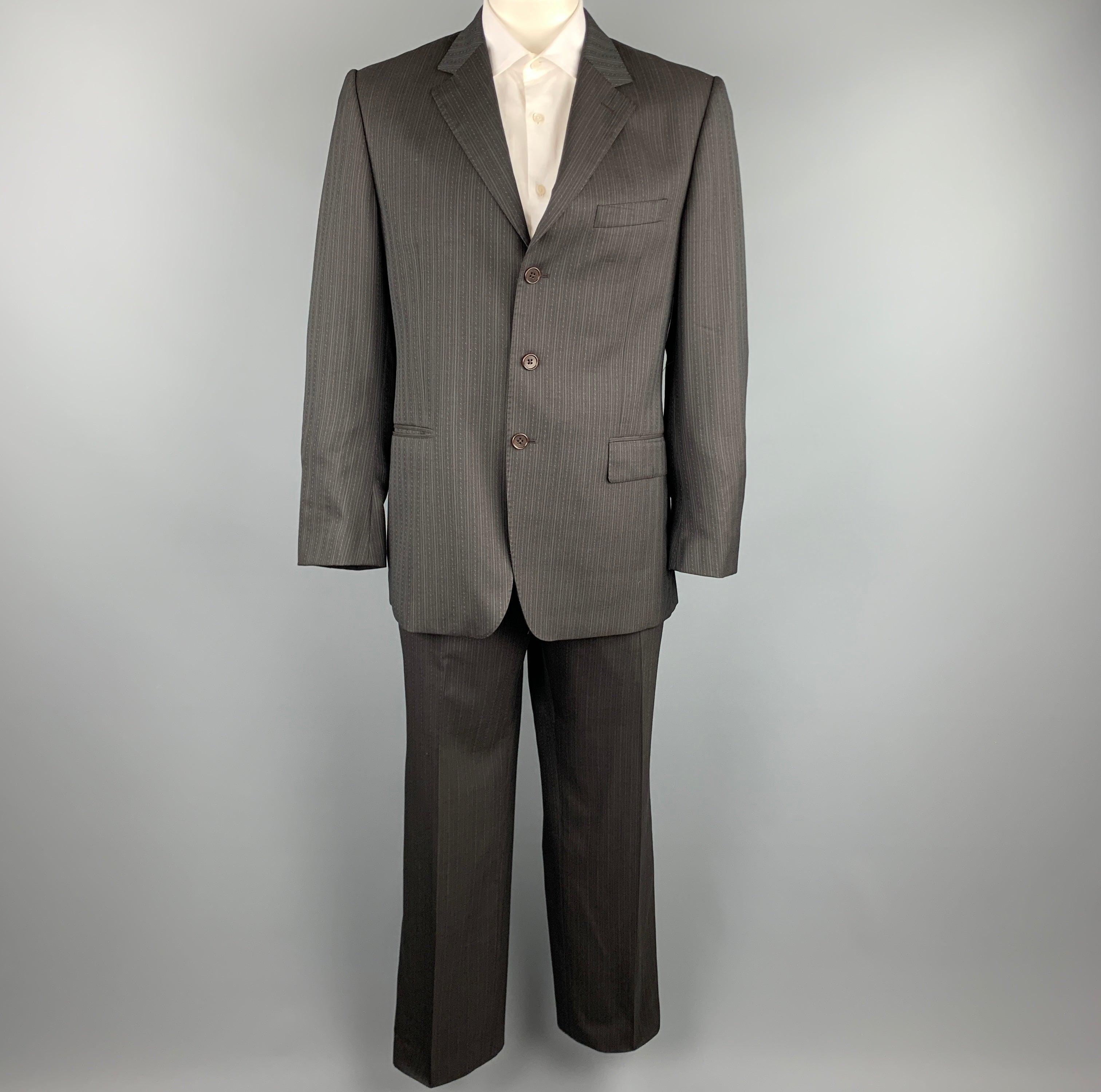 PAUL SMITH
suit comes in a brown stripe wool and includes a single breasted, three button sport coat with a notch lapel and matching flat front trousers. Made in Italy.Excellent Pre-Owned Condition. 

Marked:   42 R 

Measurements: 
 