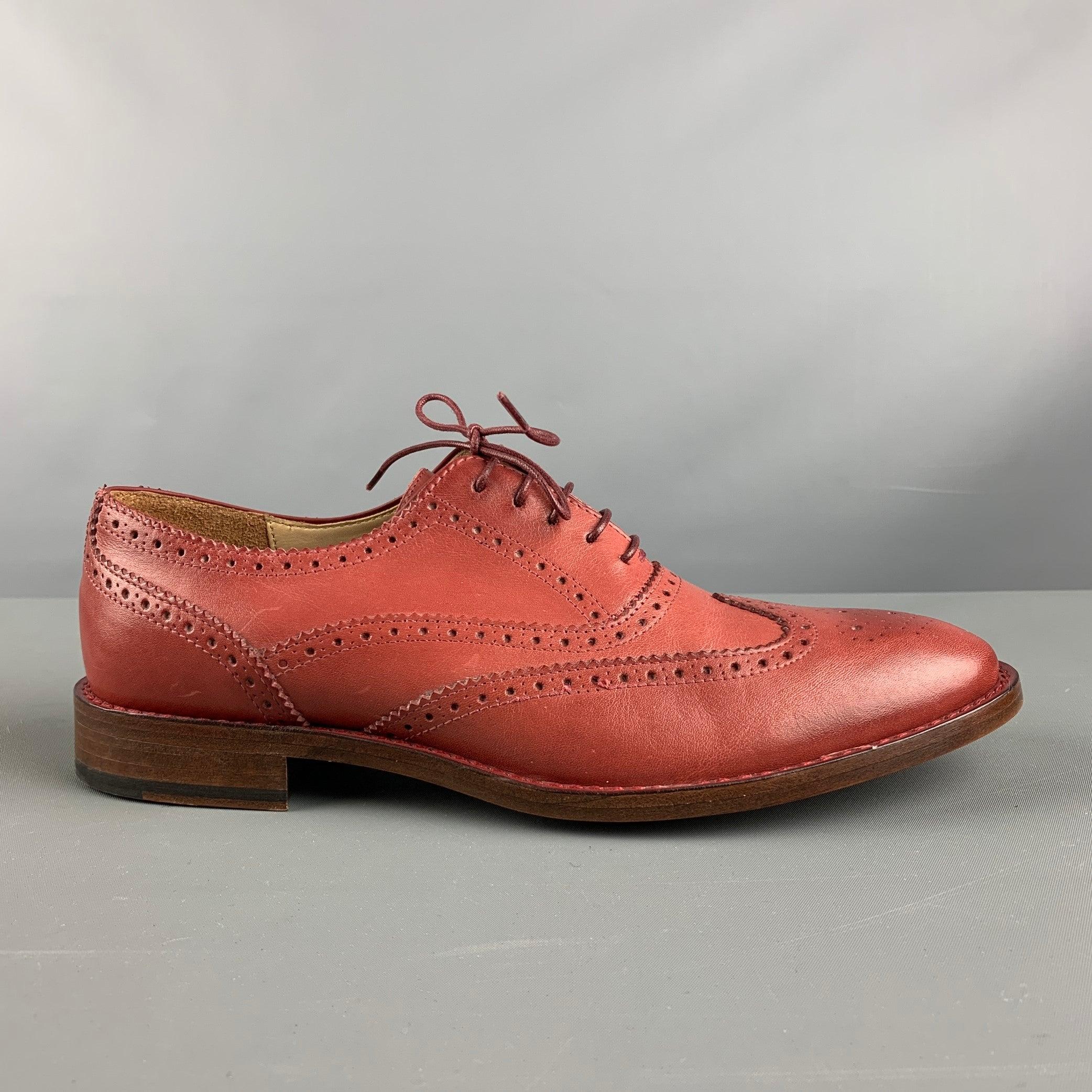 PAUL SMITH lace up shoes comes in brick perforated leather featuring a wingtip style and a leather sole. Includes Dust Bag. Made in Italy.Excellent Pre-Owned Condition. 

Marked:   MUN07 41 

Measurements: 
  Outsole: 11.75 inches  x 4 inches  
  
 