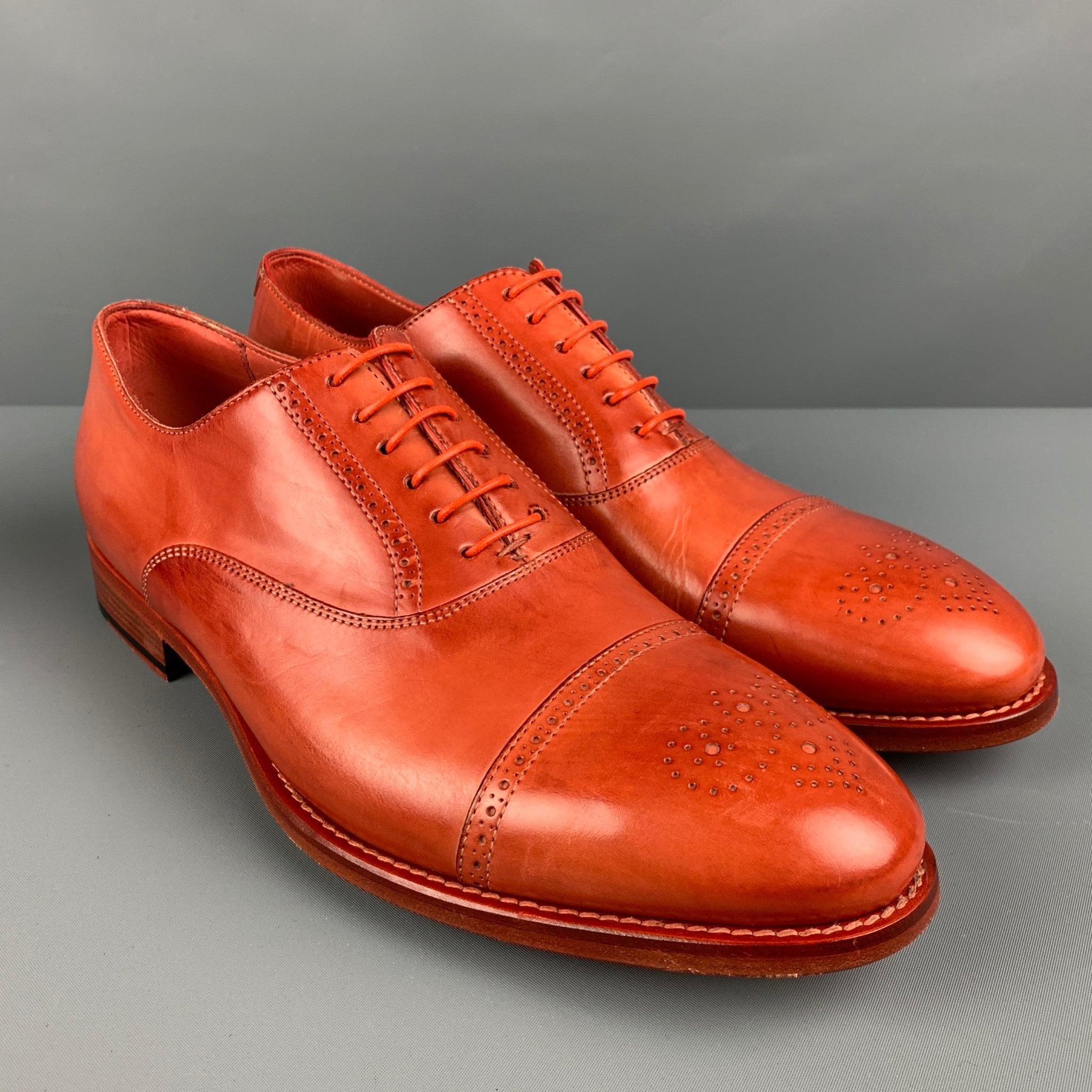 PAUL SMITH
shoes in an orange leather featuring a cap toe, perforated style, and a lace up closure. Comes with extra shoelace, dust bag, and box. Made in Italy. Very Good Pre-Owned Condition. Minor signs of wear. 

Marked:   8.5/42.5Outsole: 11.5