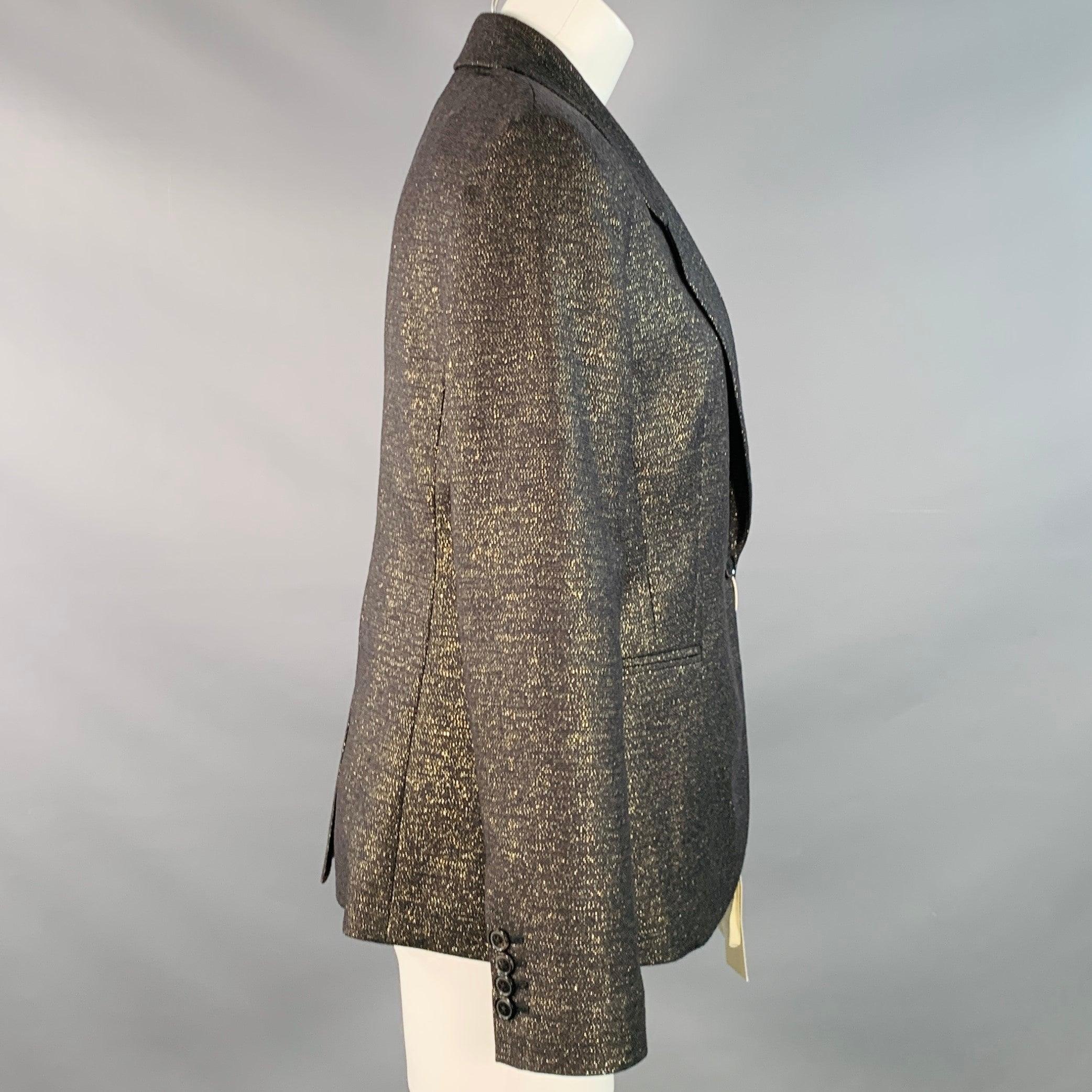 PAUL SMITH blazer in a black and metallic gold tone wool blend fabric featuring a notch lapel, single vented back, and single button closure. Made in Italy.New with Tags. 

Marked:   IT 42 

Measurements: 
 
Shoulder: 16 inches Bust: 38 inches