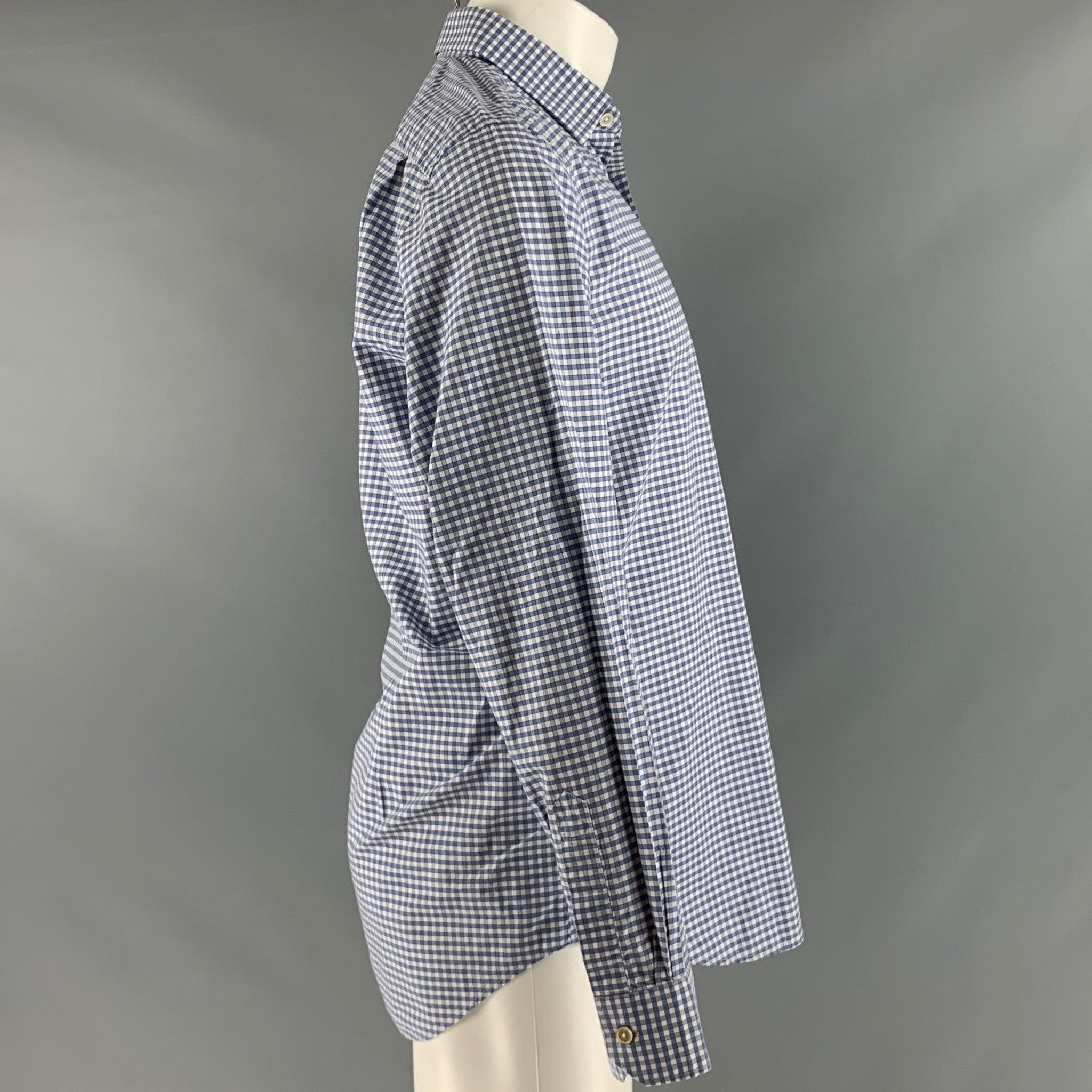 PAUL SMITH long sleeve shirt
in a blue and white cotton fabric featuring gingham pattern, spread collar, and button closure.Very Good Pre-Owned Condition. Minor pilling throughout. 

Marked:   15.5